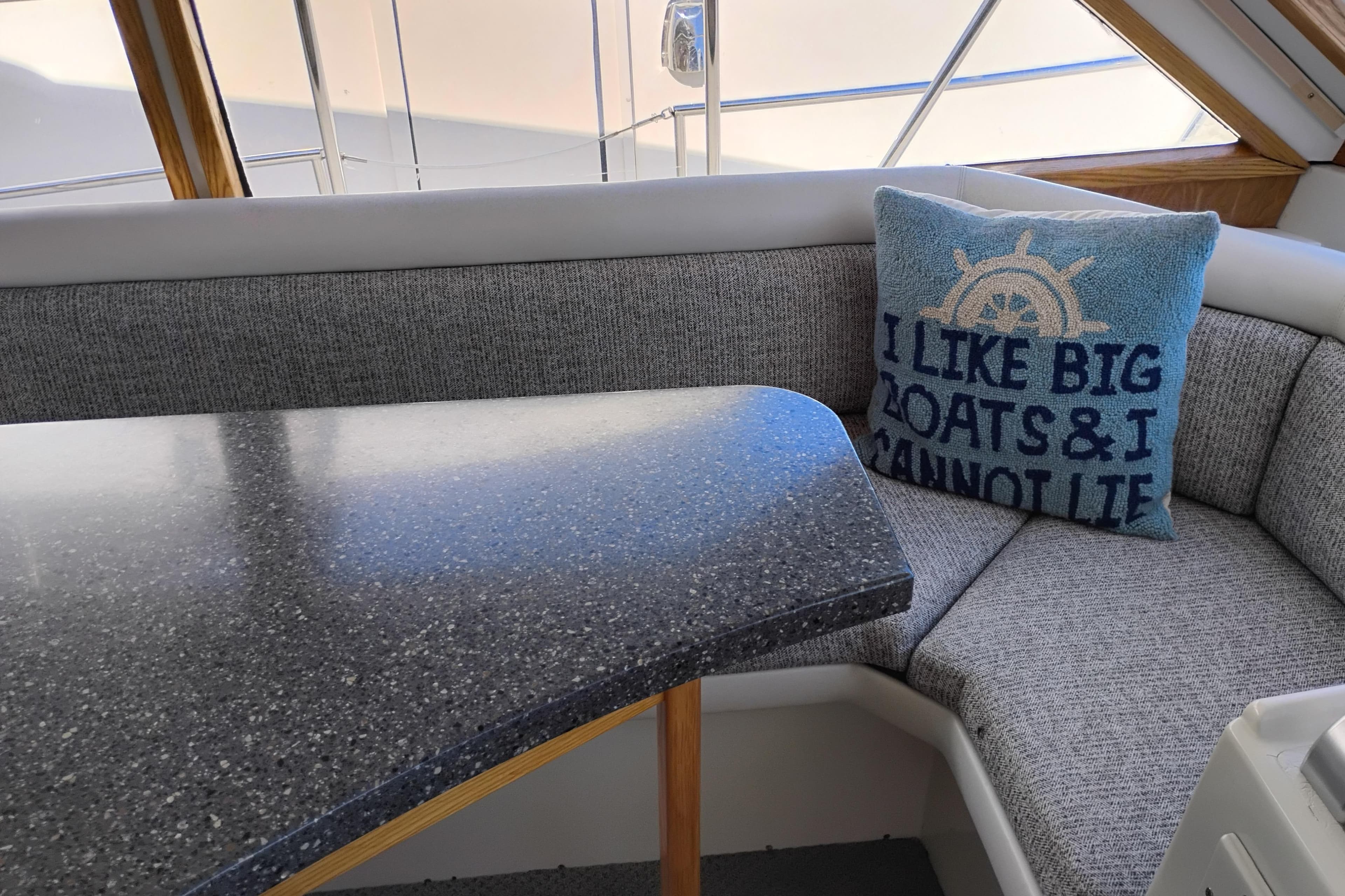 Cozy 1994 Navigator Classic boat interior with humorous nautical-themed pillow.