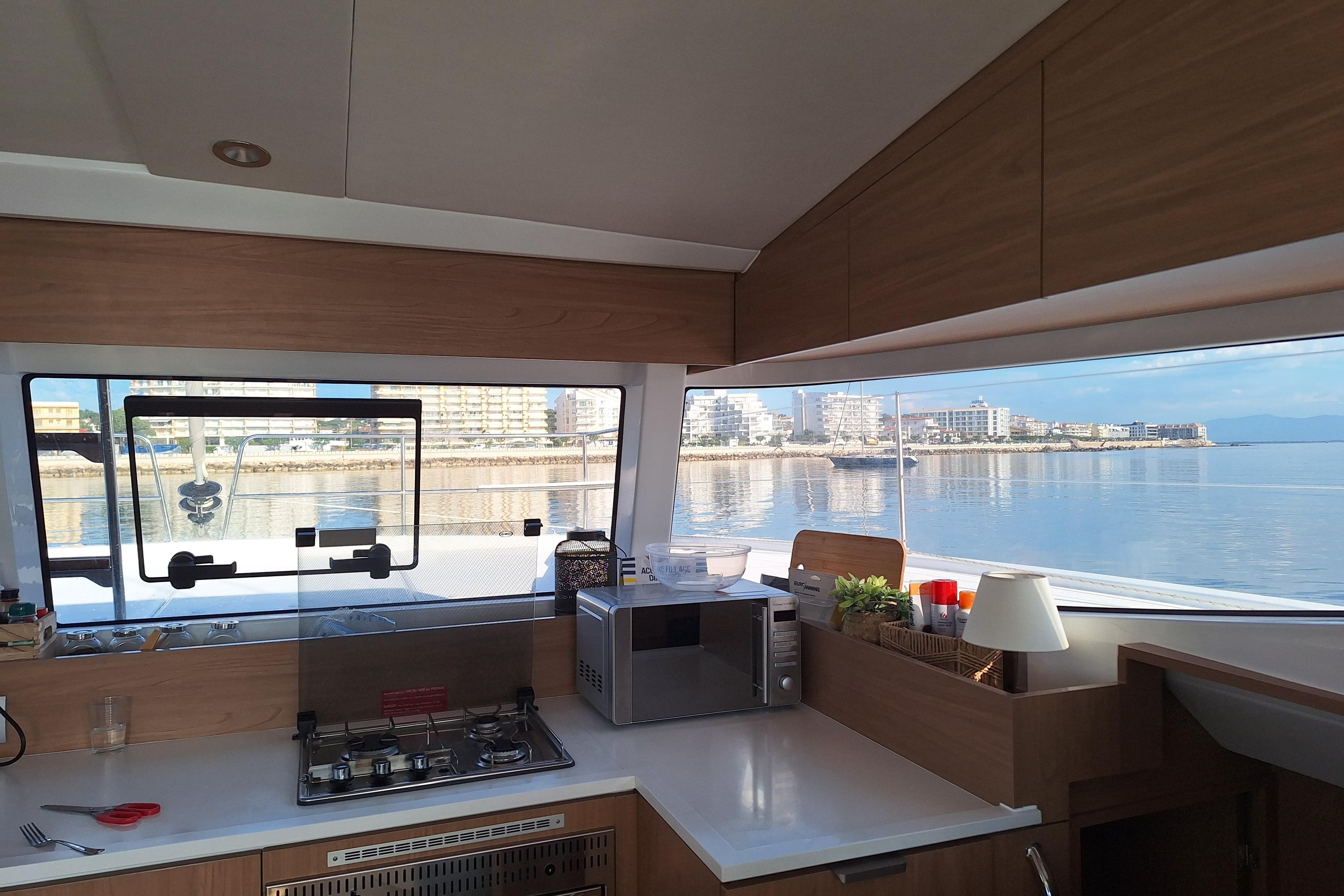 Modern kitchen interior on 2024 Bali CATSMART yacht with scenic ocean view.