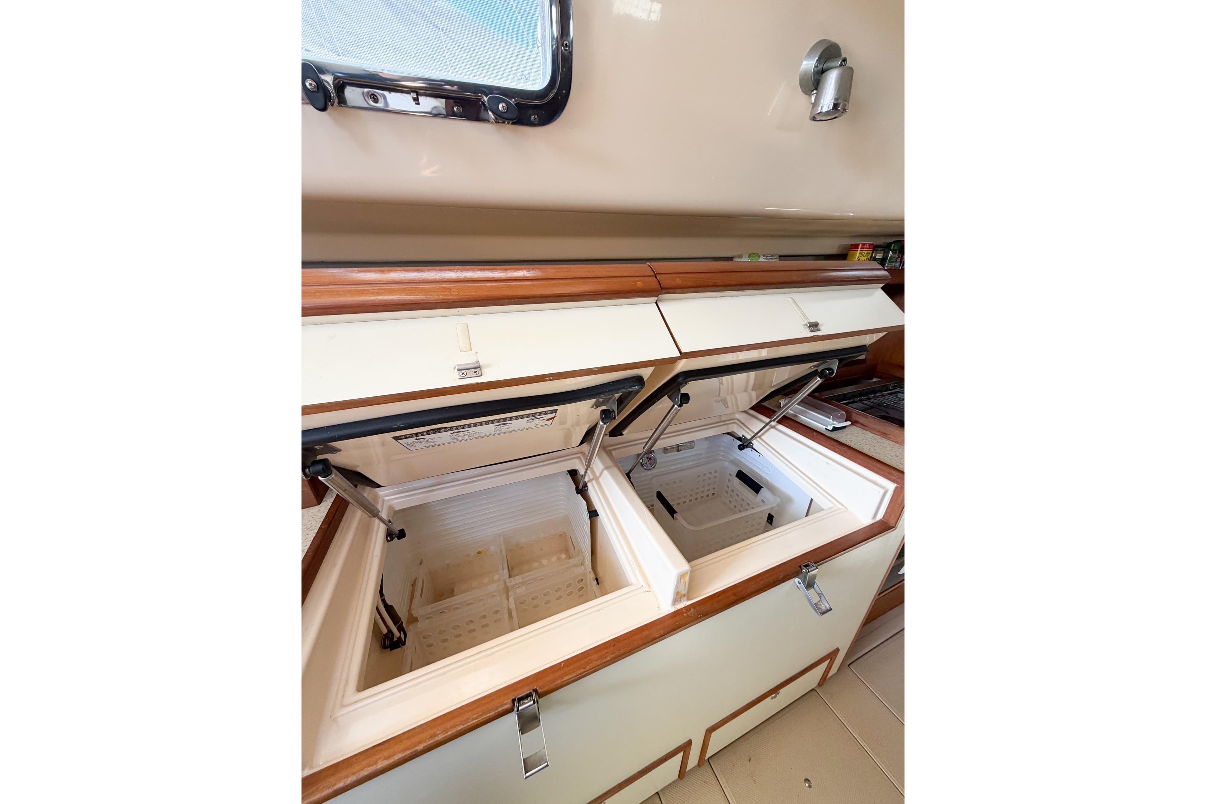 2007 Island Packet SP Cruiser interior with open dual storage compartments.