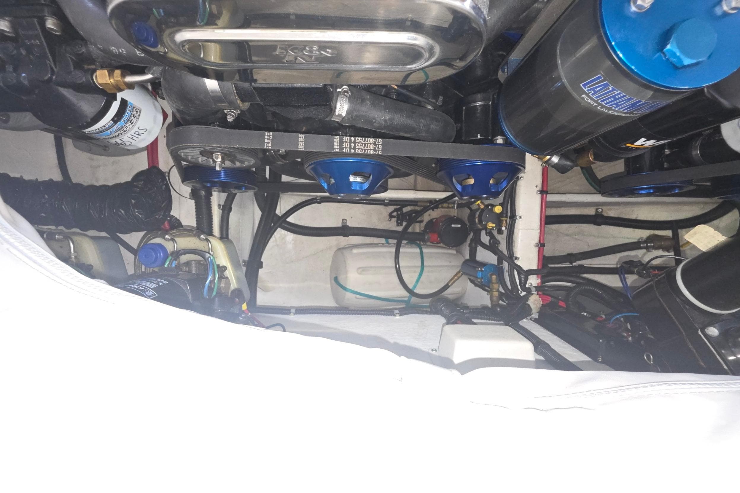 Engine compartment of a 2000 Powerquest 380 Avenger boat, showcasing mechanical components.