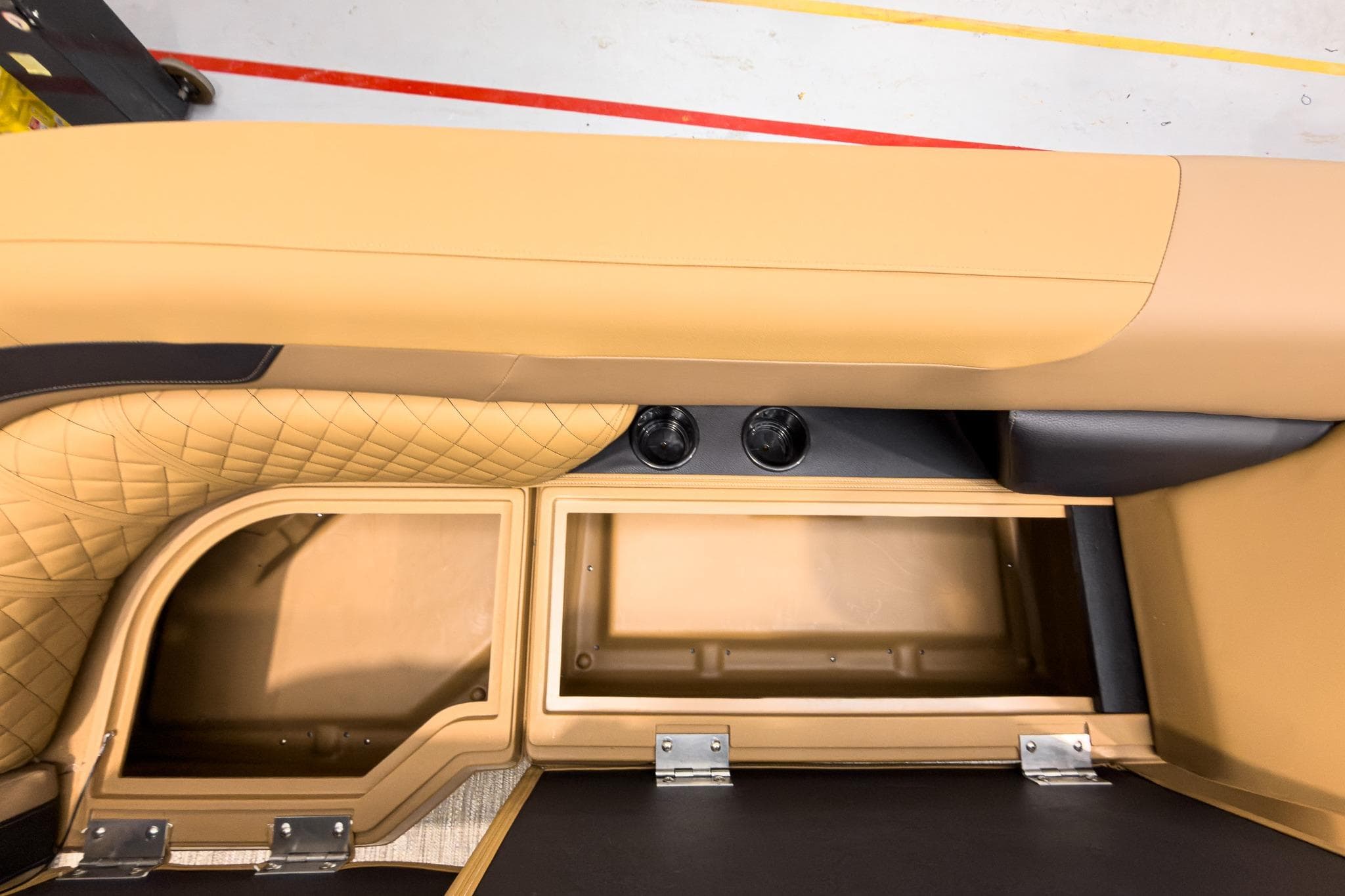 Interior view of 2026 Godfrey Sweetwater 22' Tritoon, featuring storage compartments and cup holders.