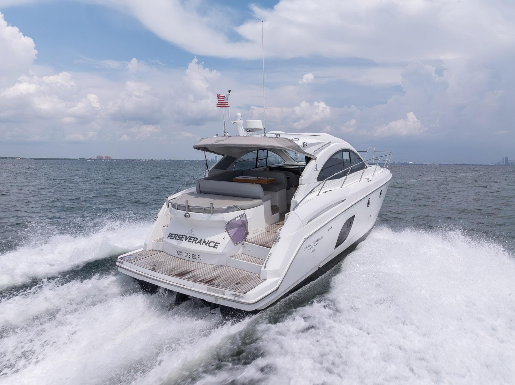 2014 Beneteau Gran Turismo 44 yacht cruising on open water, rear view.