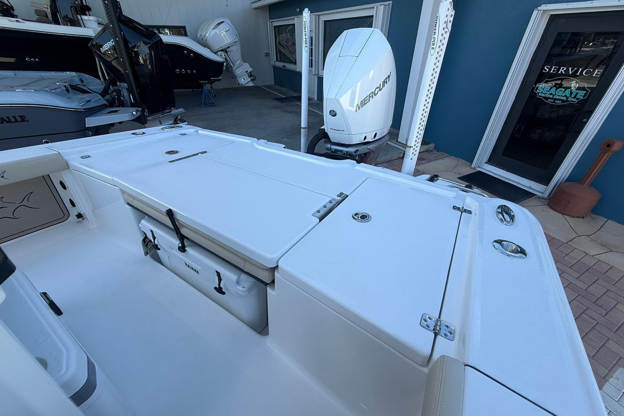 2026 Crevalle 24 HCO boat with Mercury engine, docked near service area.