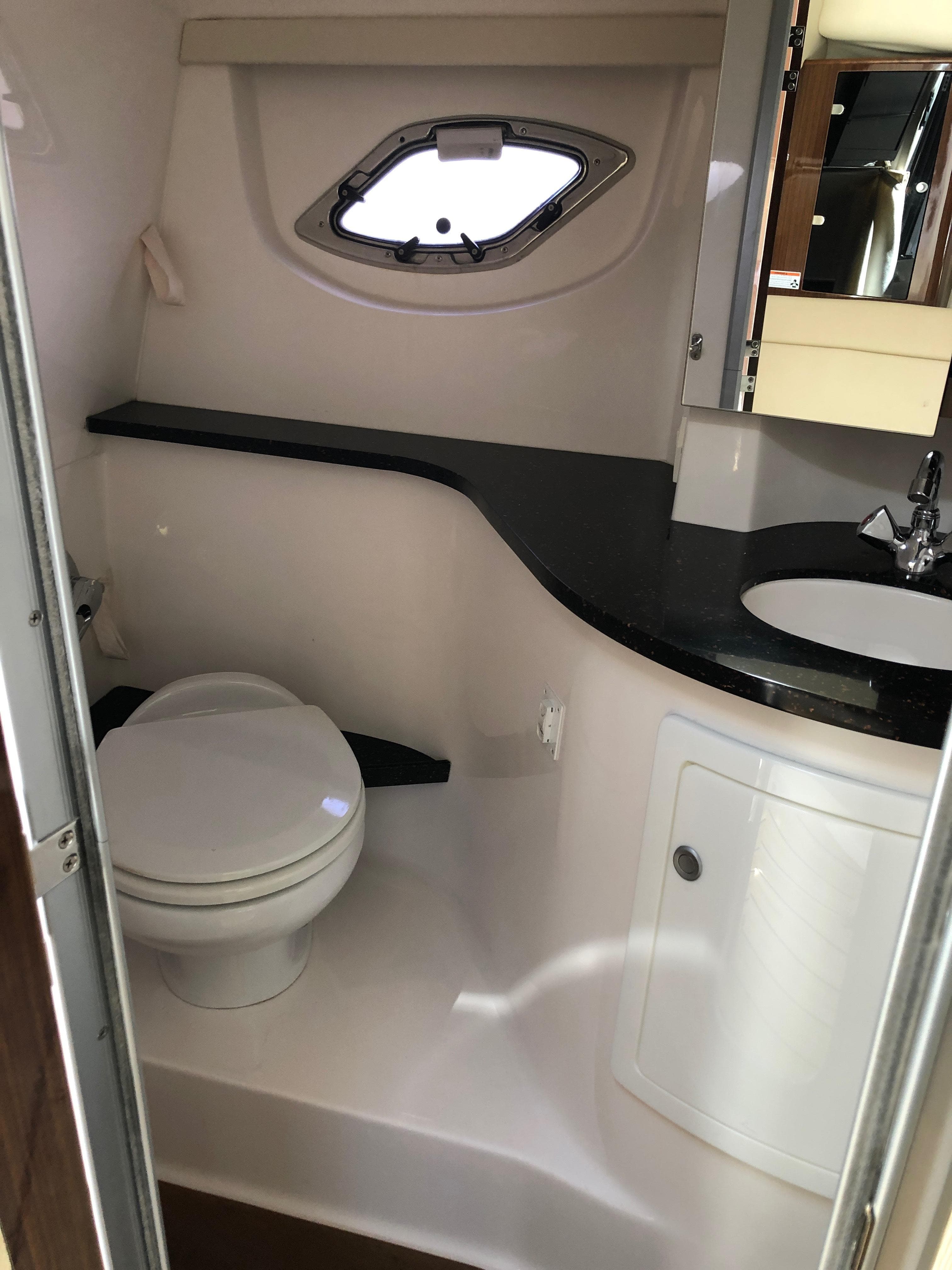 2013 Regal 35 Sport Coupe bathroom with modern fixtures and porthole window.