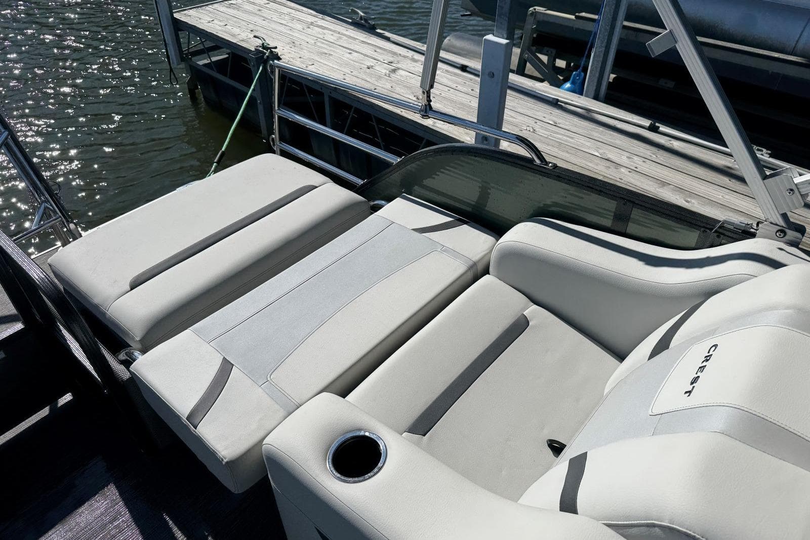 2024 Crest Classic LX 220 SLRC boat with luxurious seating by the dock.