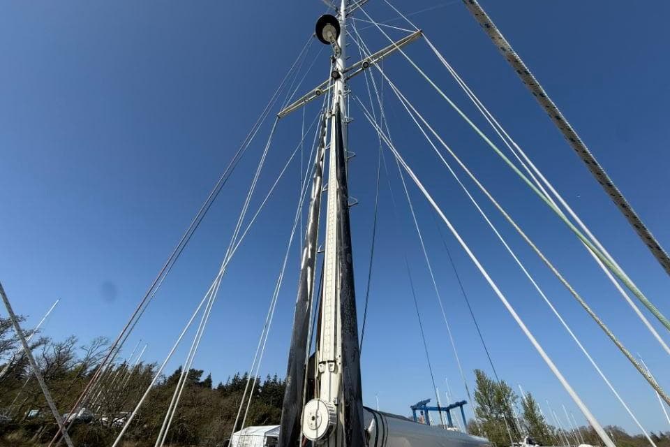 Mast of a 2001 Bowman 48 sailboat against a clear blue sky.