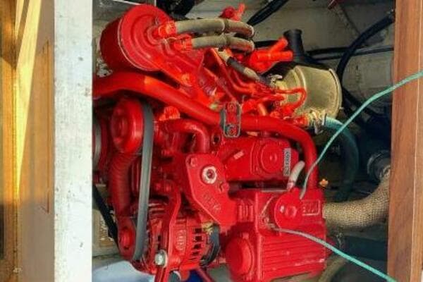 Red engine of a 1997 Custom 30 Performance Sloop, detailed view.