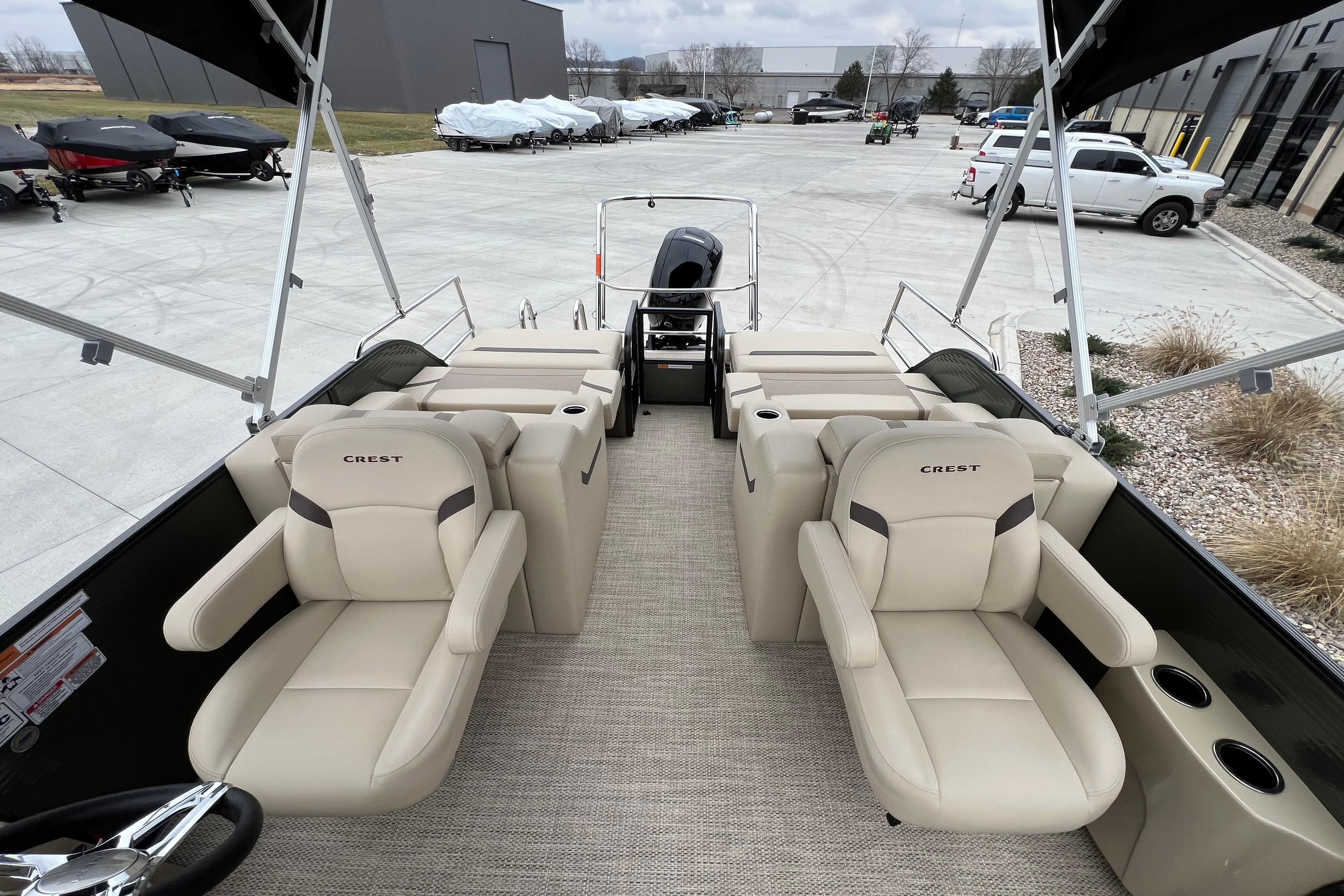 2024 Crest Classic LX 220 SLRC pontoon boat with beige seating and modern design.