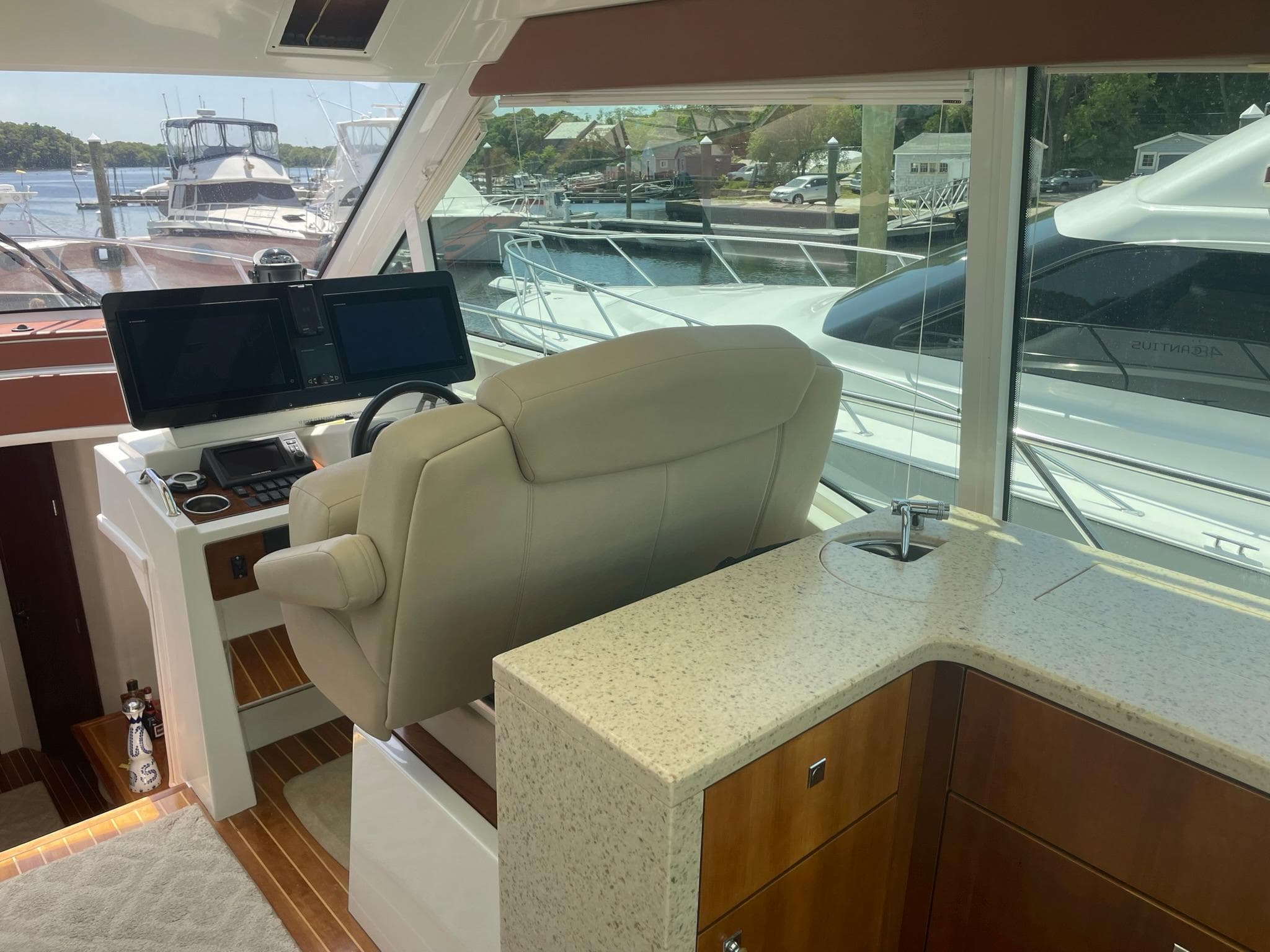Interior helm of 2012 Cruisers Yachts 48 Cantius with modern controls and seating.
