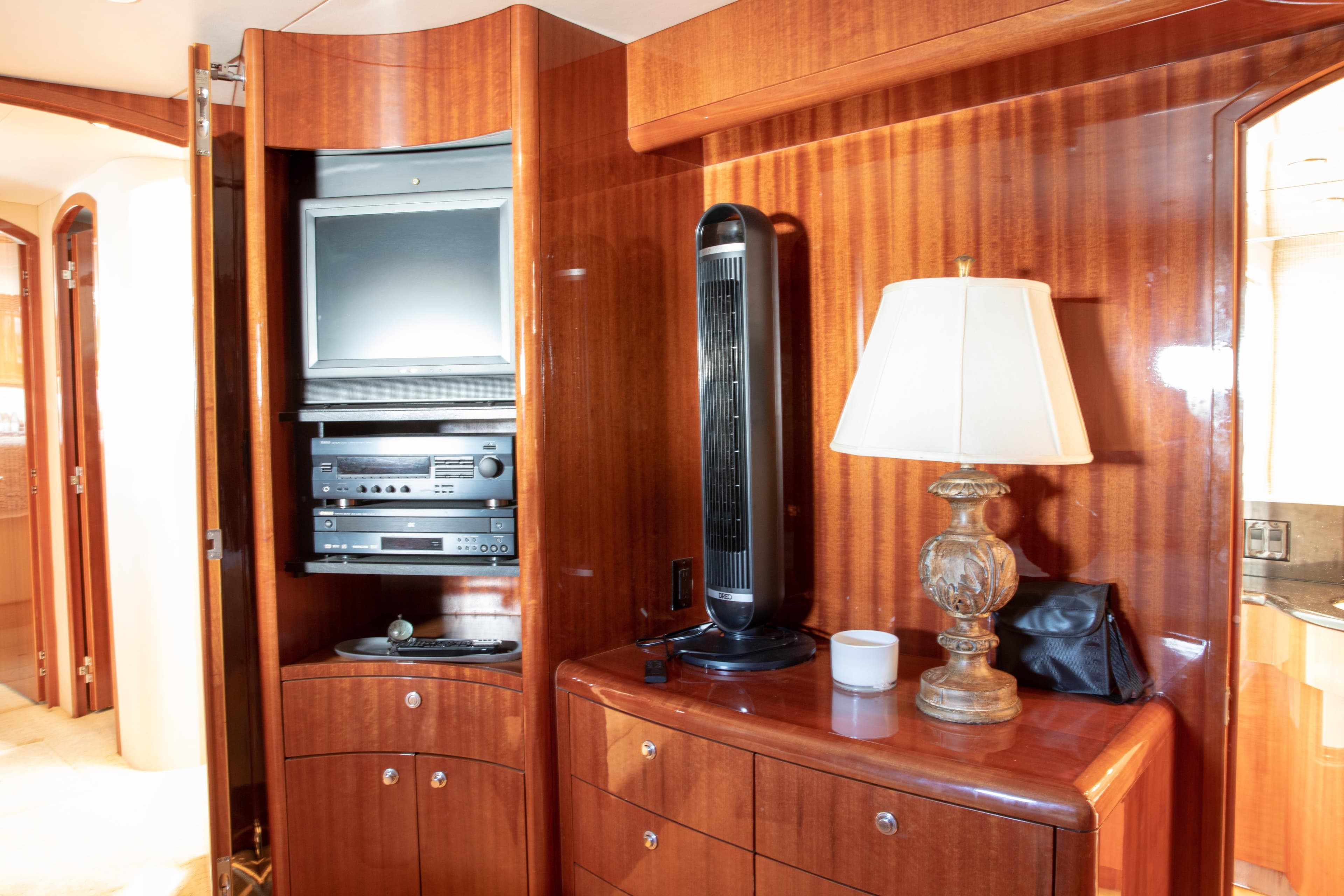 Luxurious interior of 2002 Hatteras 63 Yacht with TV, fan, and lamp.