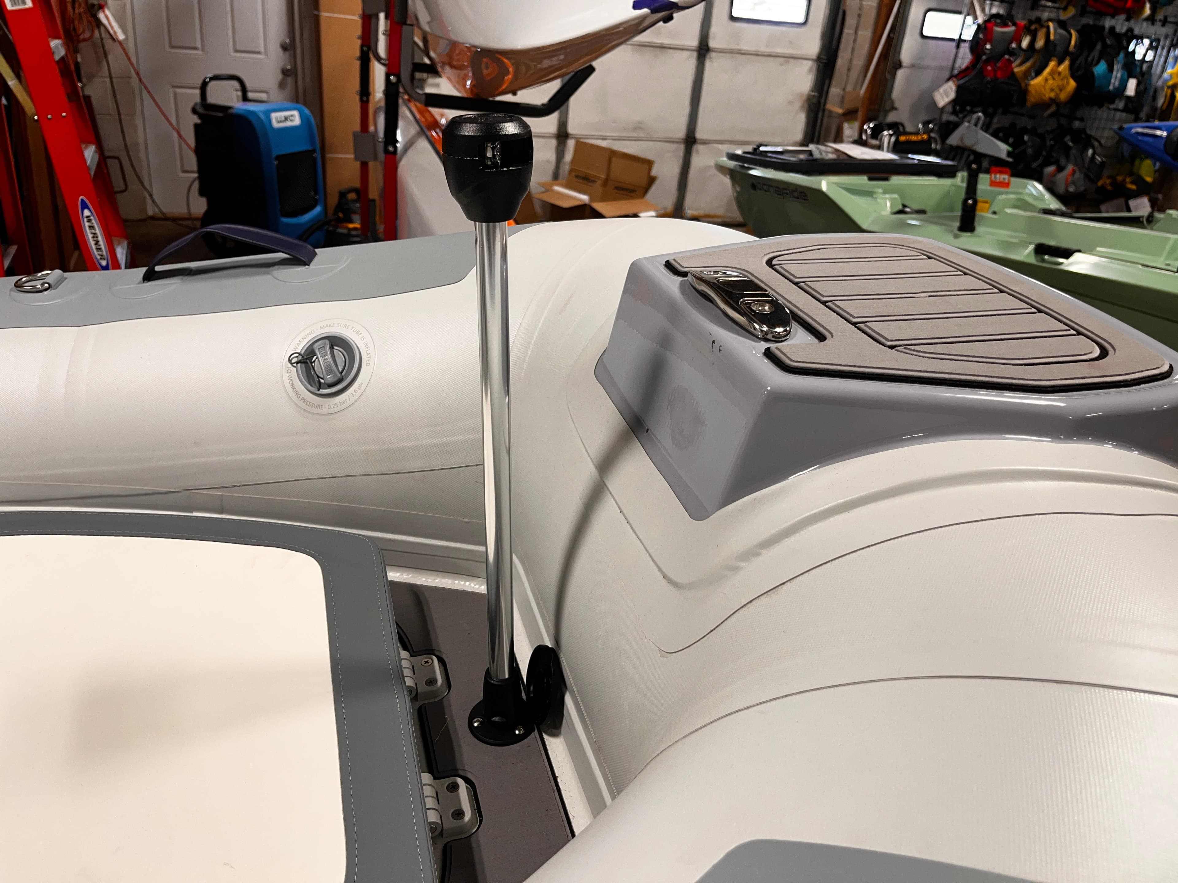 2025 Highfield Classic 310 FCT boat interior with steering column in a garage setting.