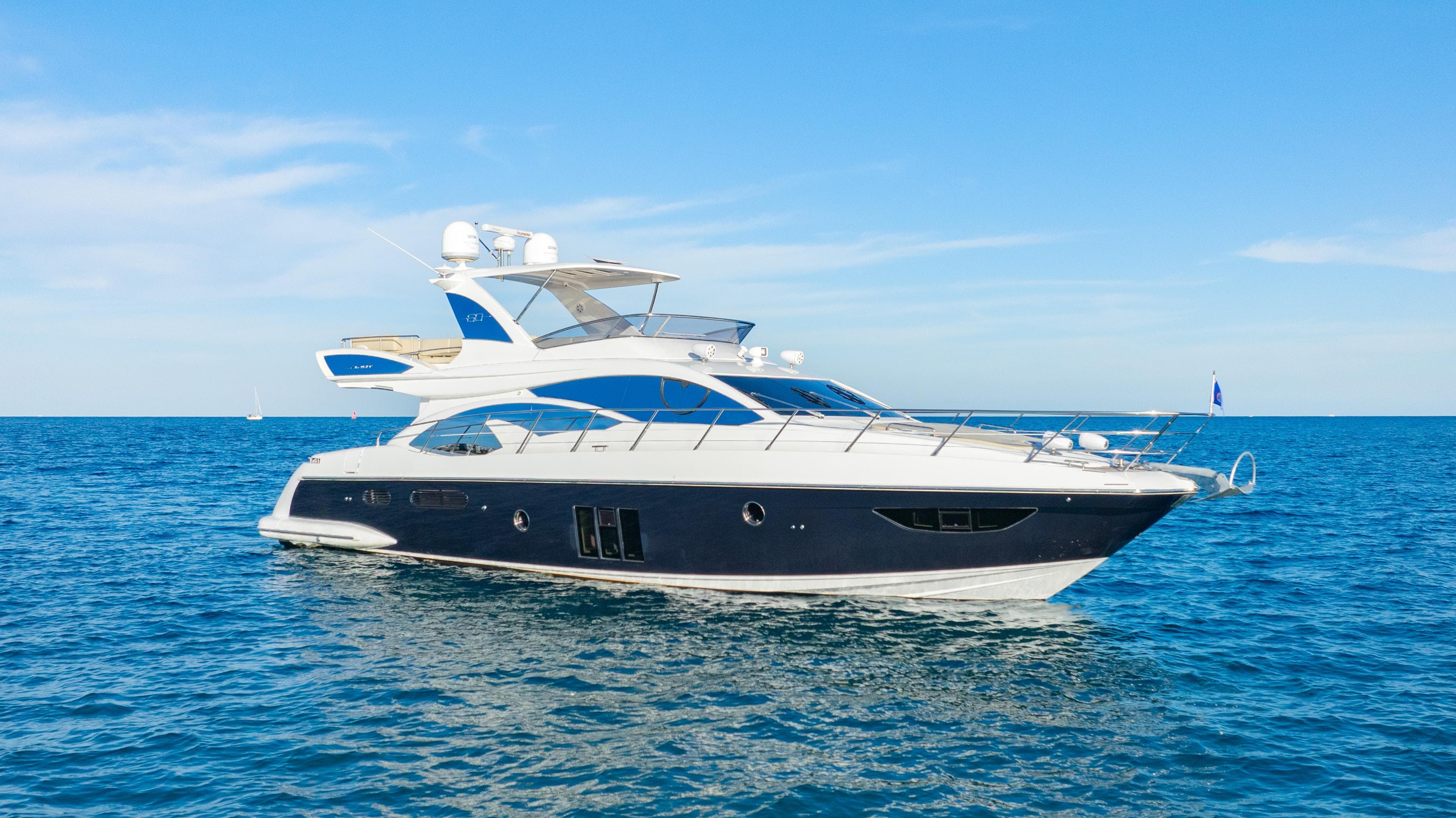 2017 Azimut 60 Flybridge yacht cruising on open sea under clear blue sky.