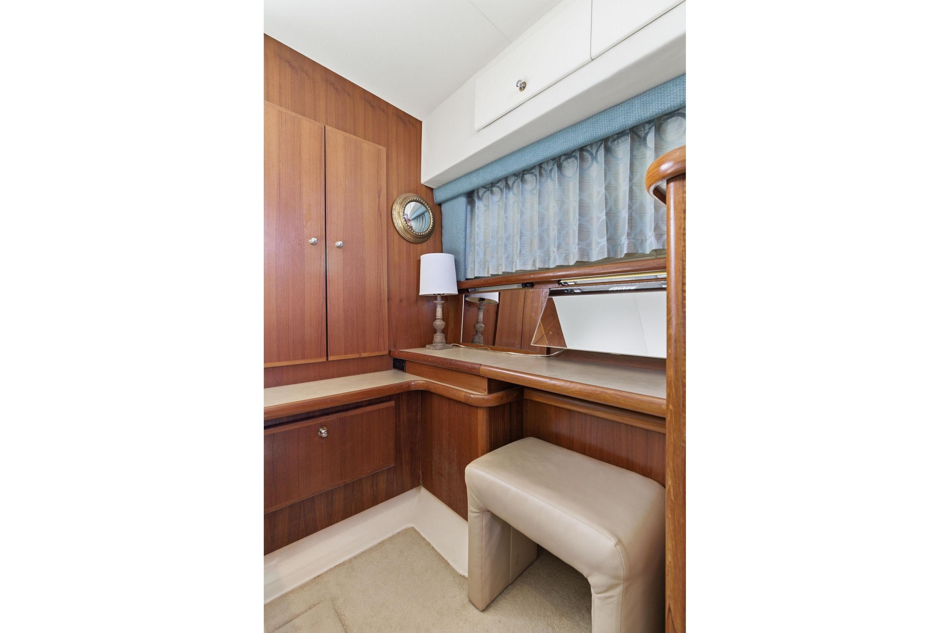 1998 Carver 445 Aft Cabin Motor Yacht interior with wooden cabinetry and seating area.