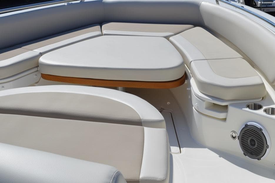 2018 Boston Whaler 420 Outrage boat seating area with cushioned seats and cup holders.