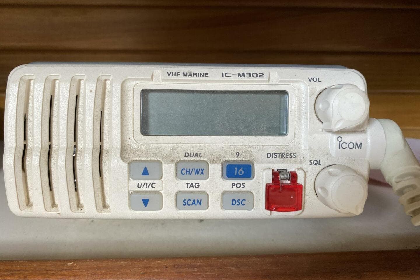VHF marine radio IC-M302 on 1986 Catalina 34 sailboat, featuring distress and channel controls.