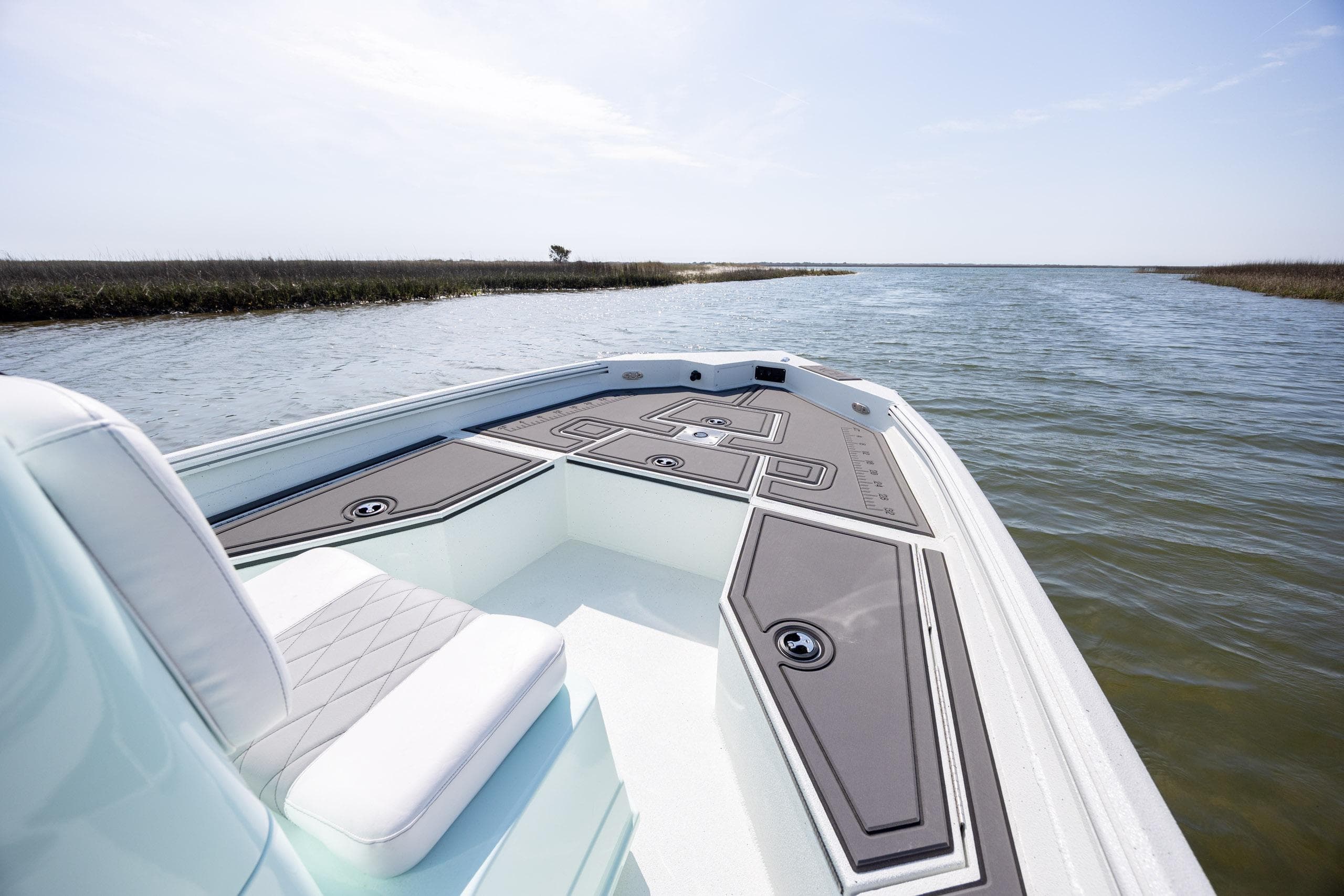 2026 Excel 203 Bay Pro Elite boat on calm water, featuring sleek deck design.