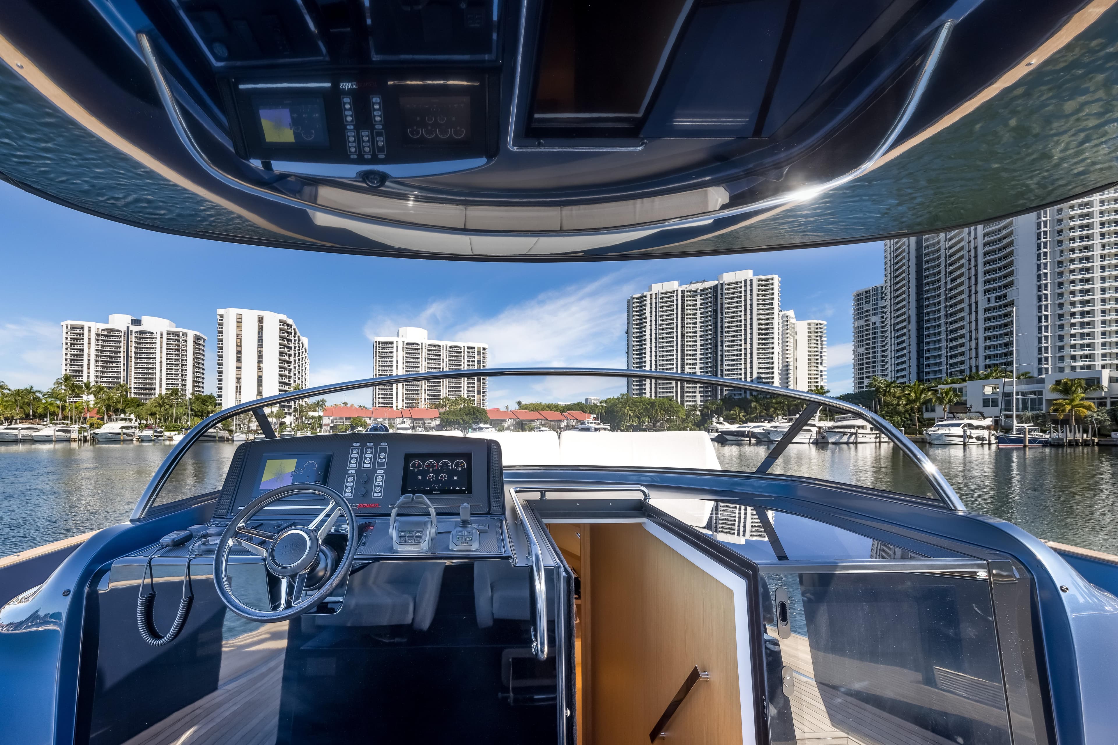 Cockpit view of 2021 Solaris Power 48 OPEN yacht with city skyline backdrop.