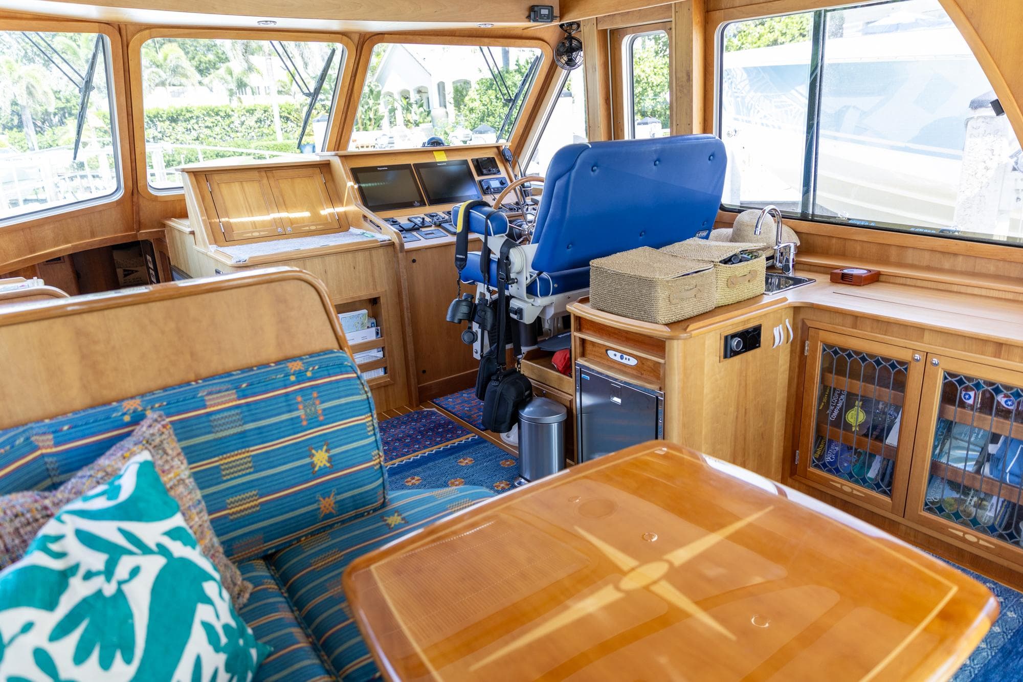 Interior of 2009 Sabre 52 Express yacht with wooden furnishings and blue seating.