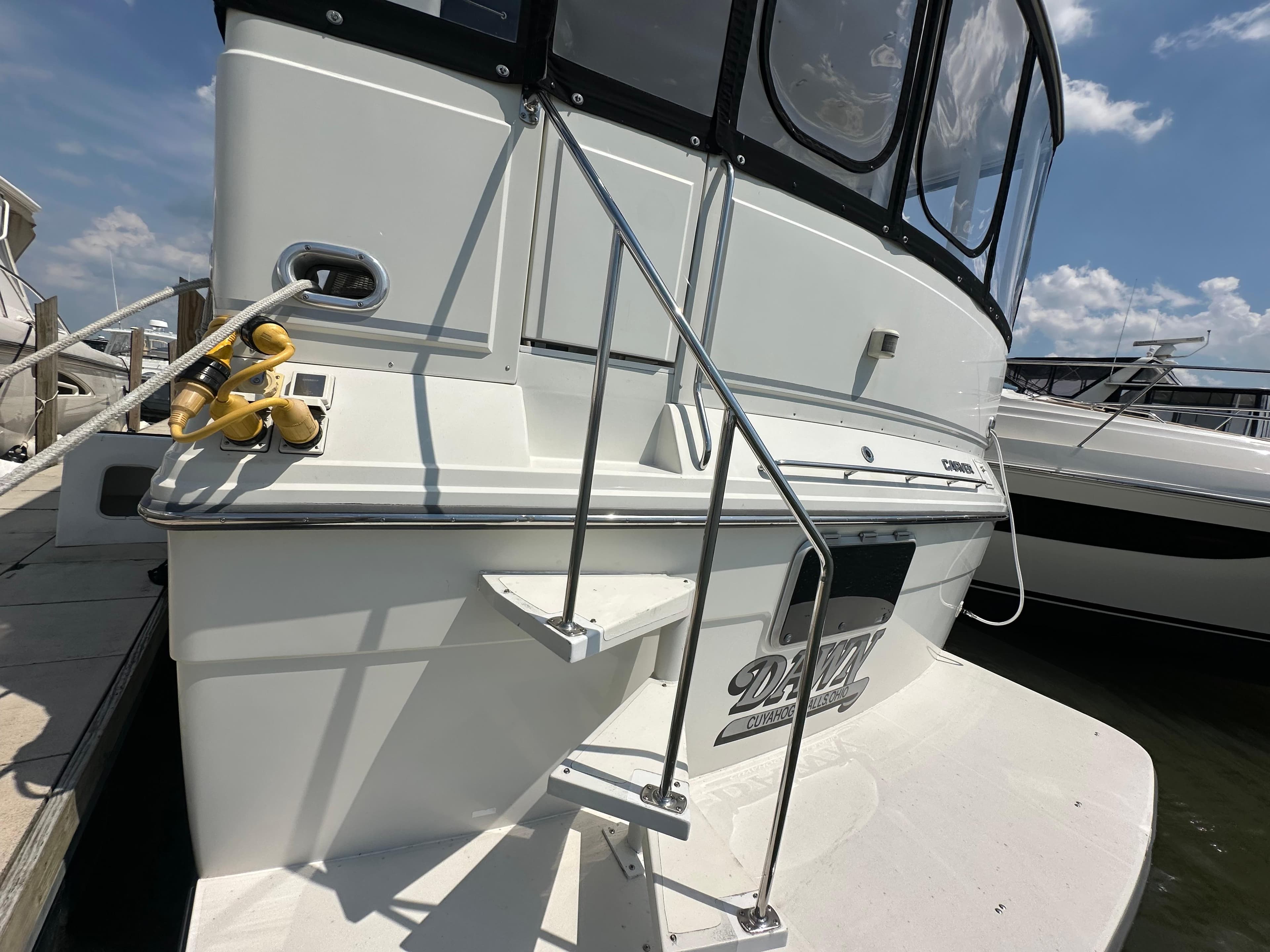 1995 Carver 440 Aft Cabin Motor Yacht docked, showing rear deck and ladder.
