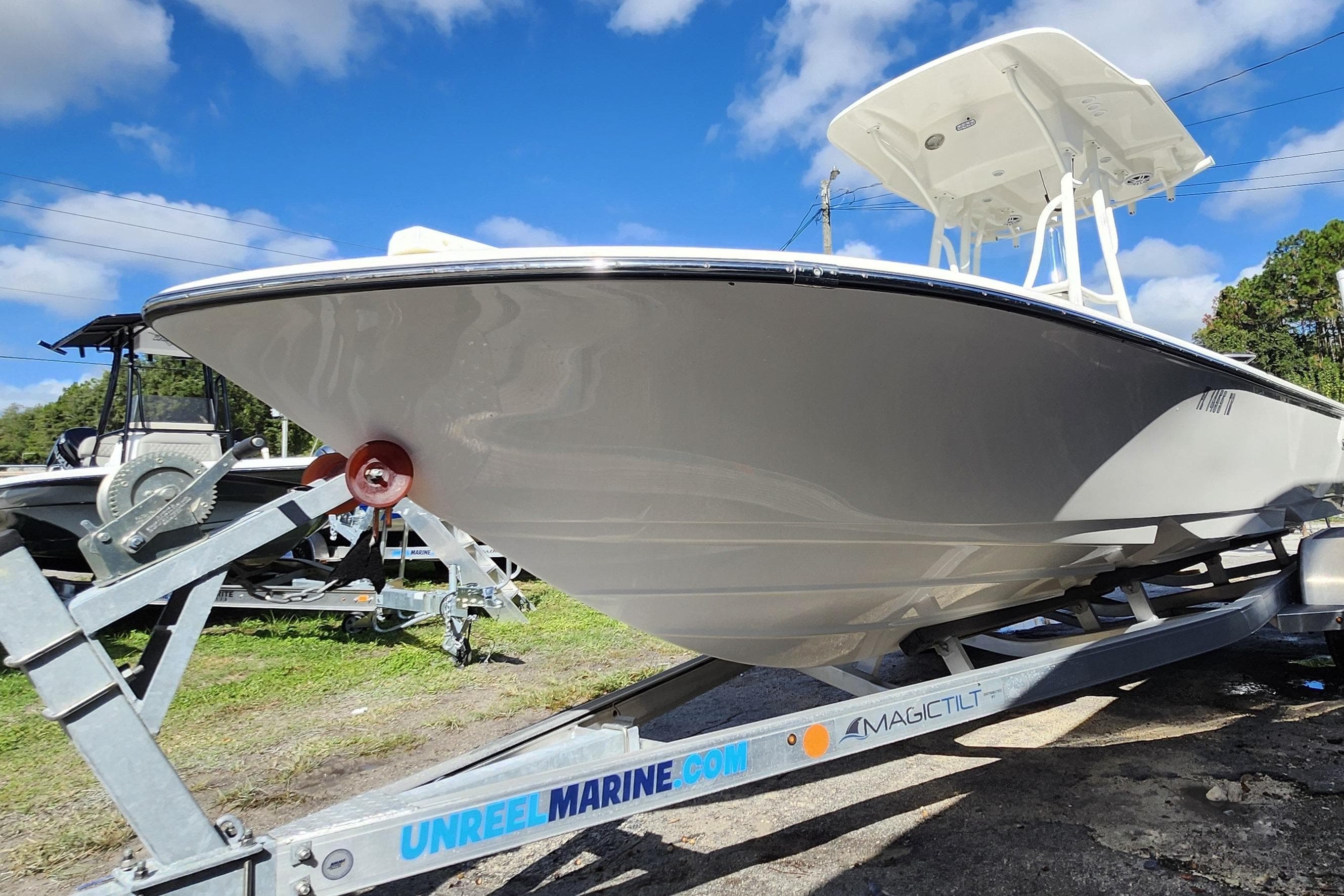 2023 Sea Born FX22 Bay boat on trailer under blue sky.