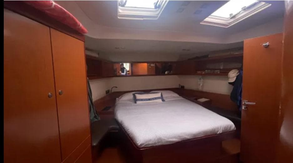 Luxurious cabin interior of 2011 Beneteau Oceanis 58 yacht with skylights and wooden furnishings.