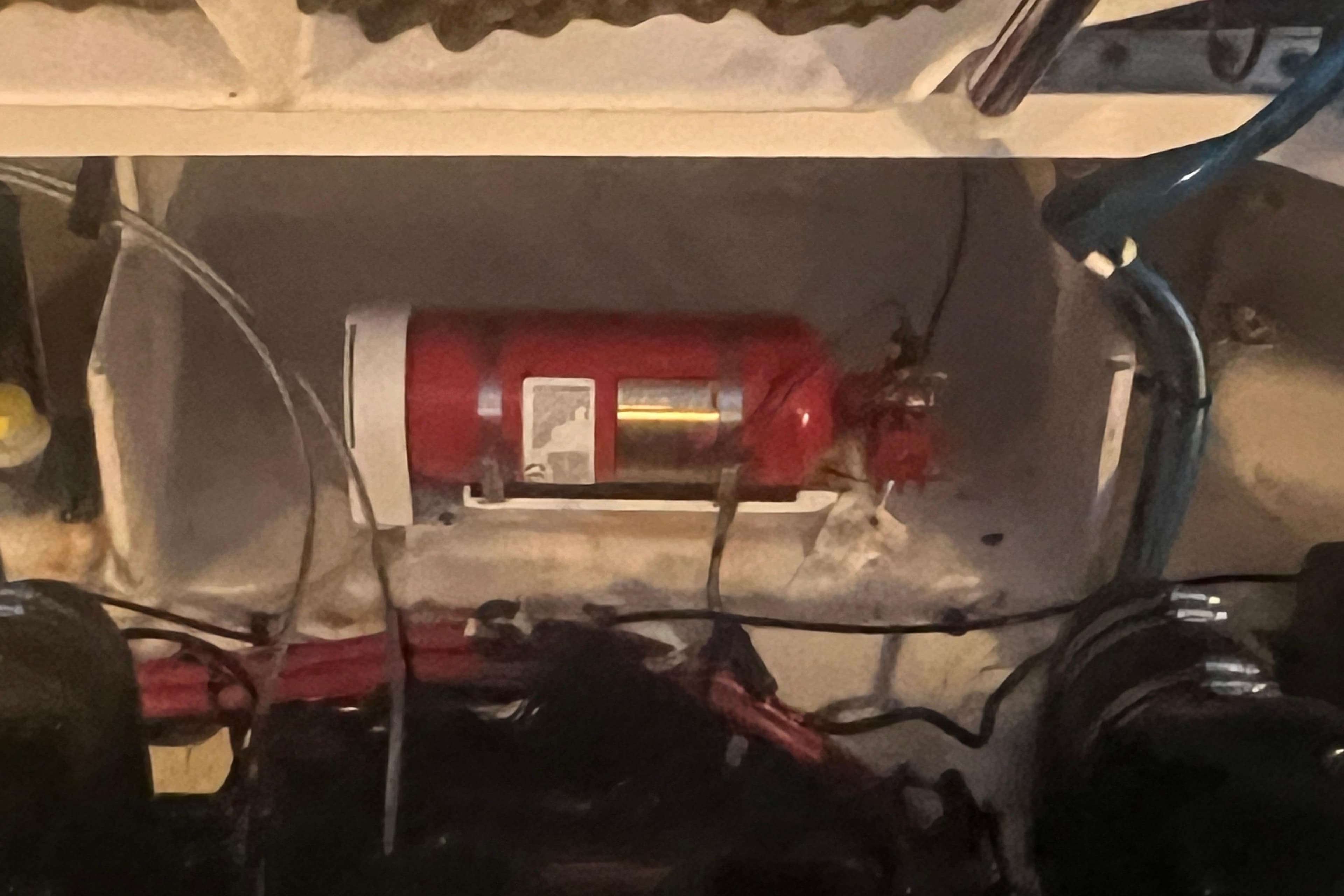 Fire extinguisher in 2007 Sea Ray 260 Sundancer engine compartment.