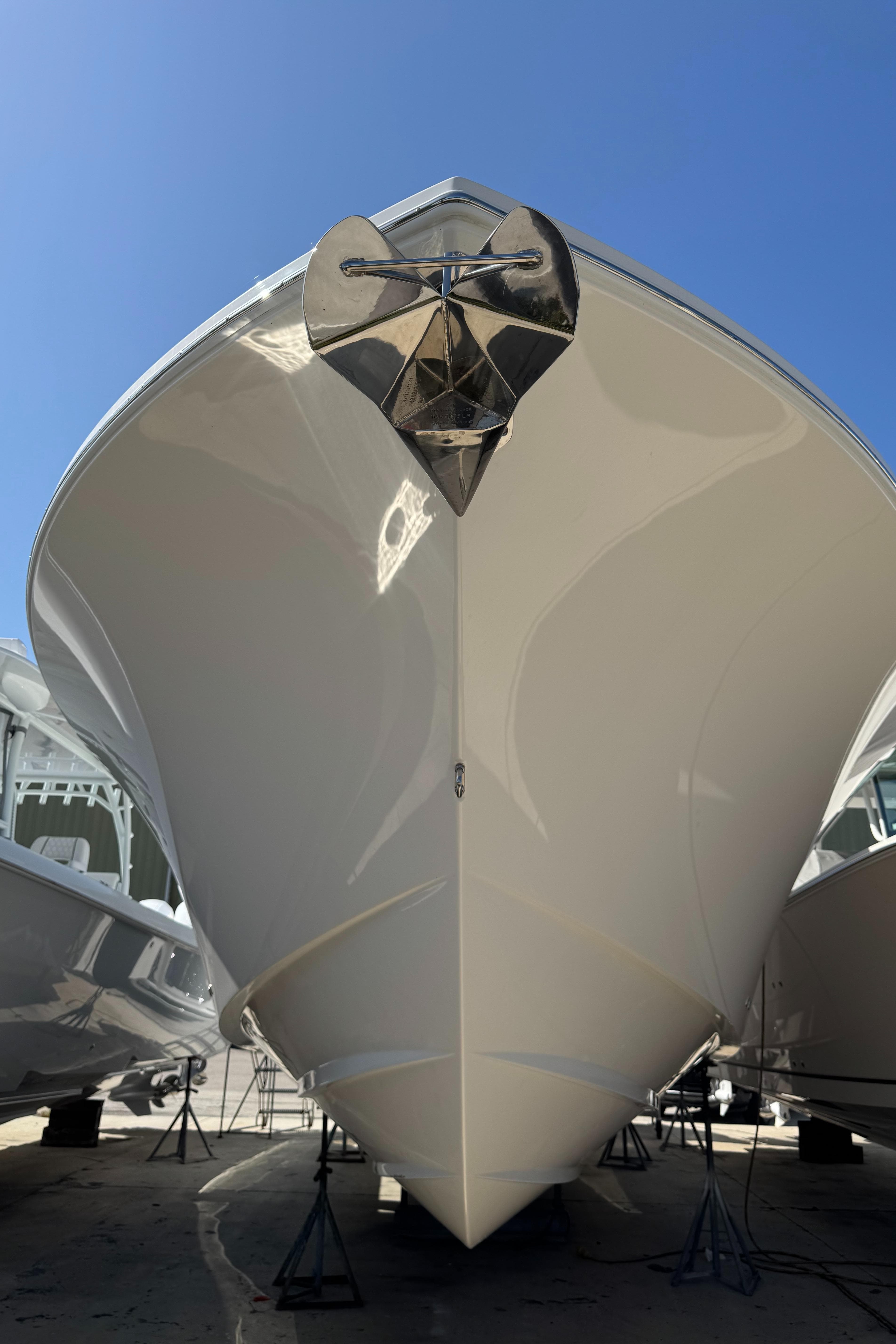 2025 Regulator 37 boat, sleek design, viewed from the front, anchored on stands.