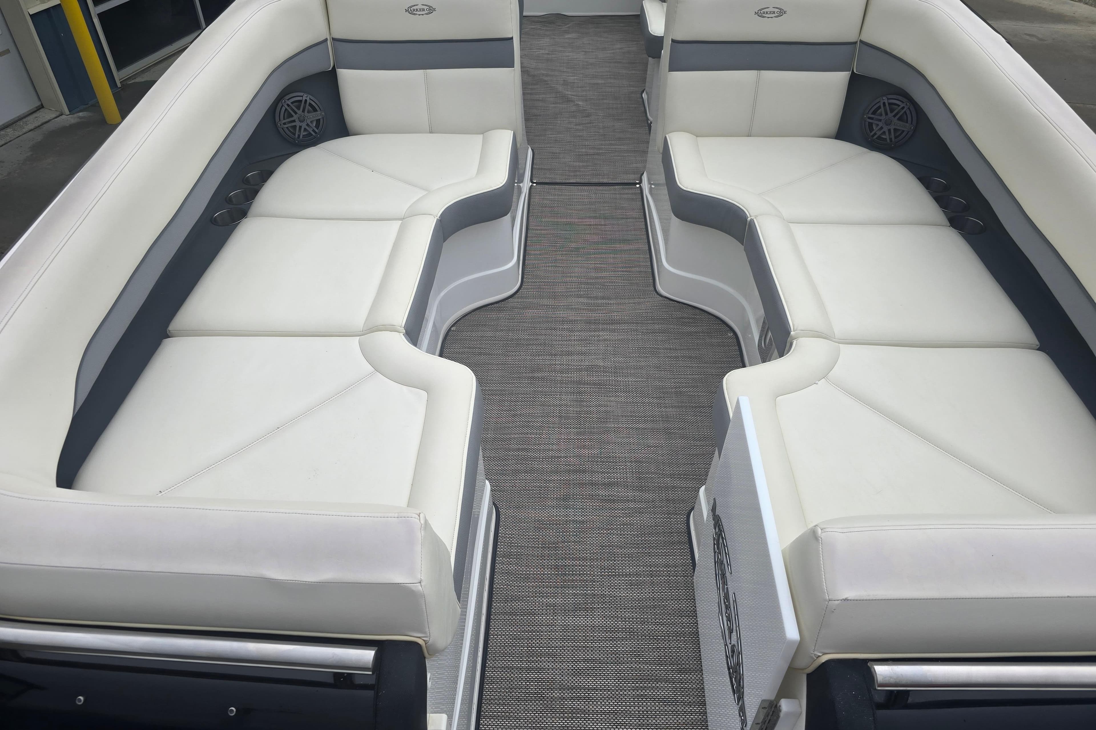 Luxurious seating on a 2016 Marker One ML4 boat, featuring white and gray upholstery.