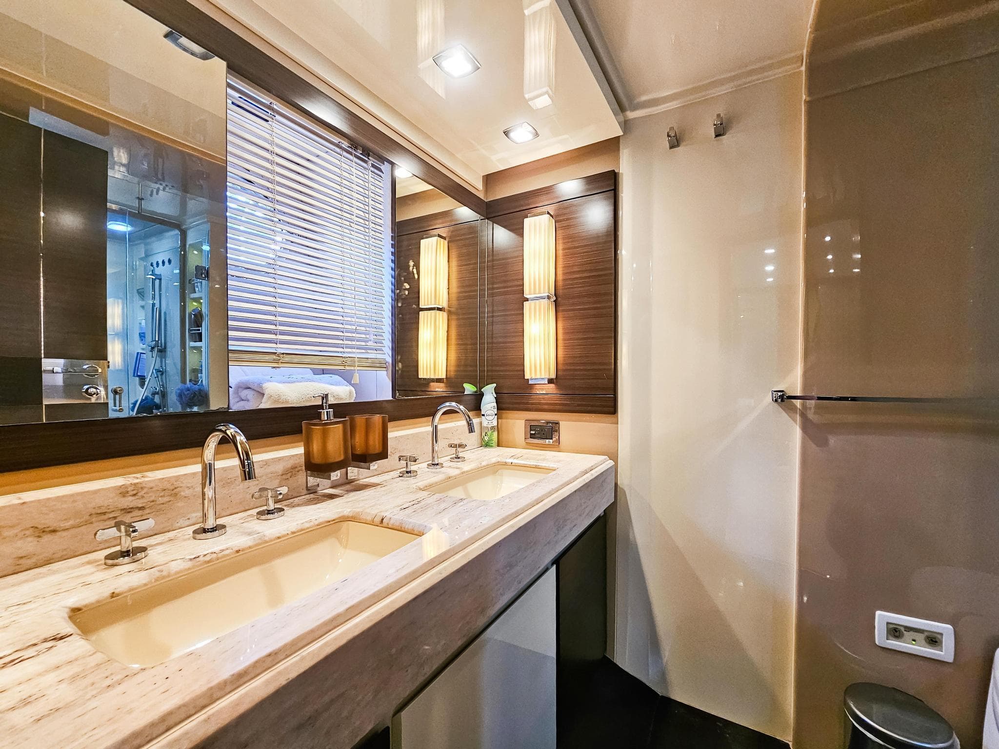 Luxurious bathroom in 2013 Azimut 70 yacht with double sinks and modern lighting.