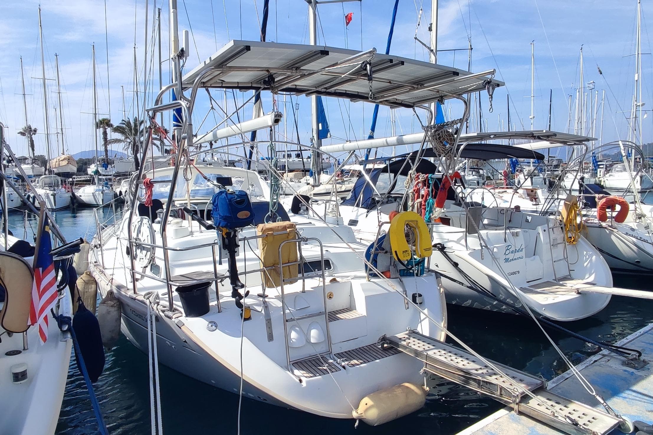 Sailboats docked at marina, featuring a 1997 Beneteau Oceanis 36 CC.