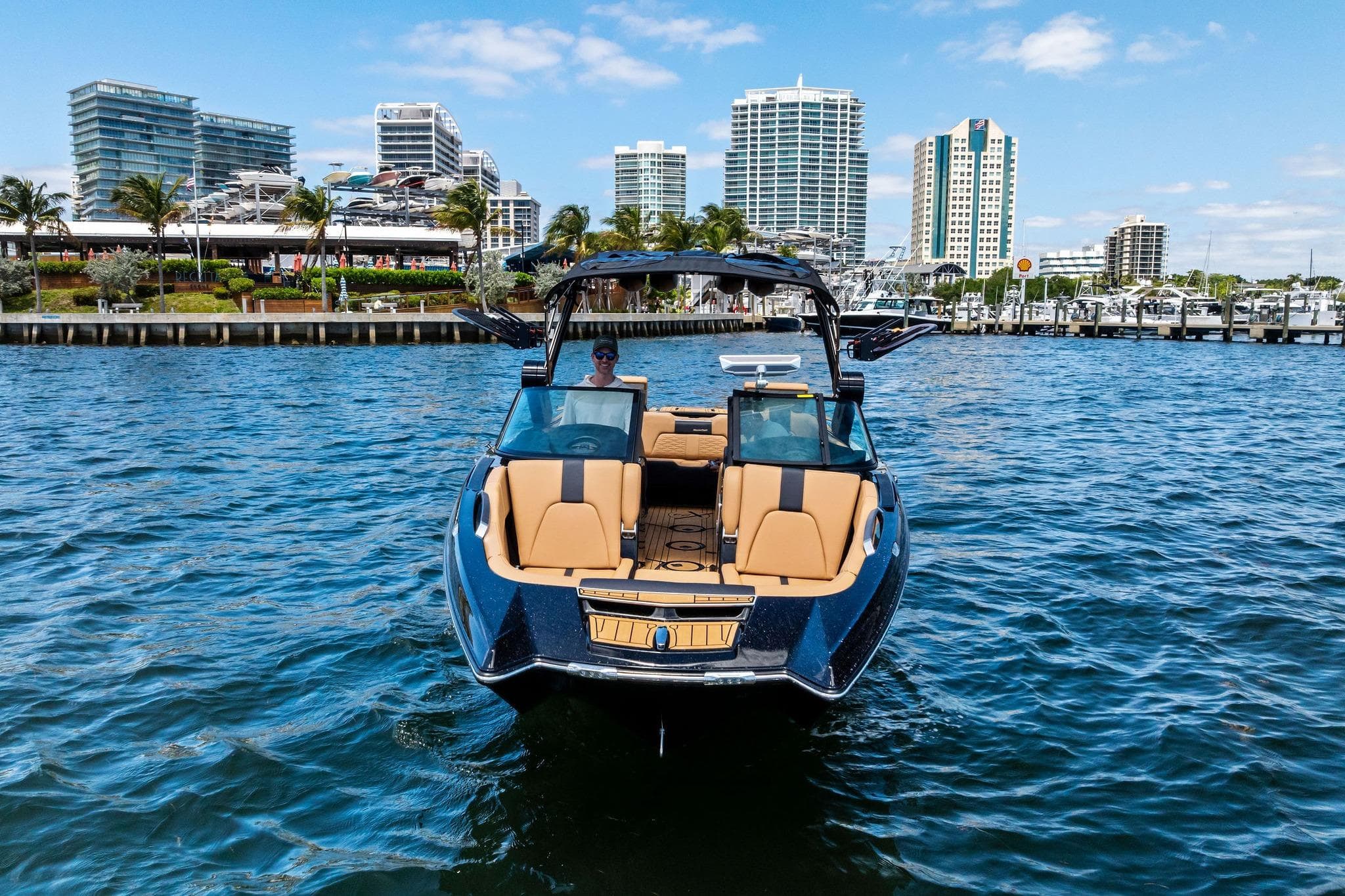2024 MasterCraft X24 boat on water with city skyline in background.