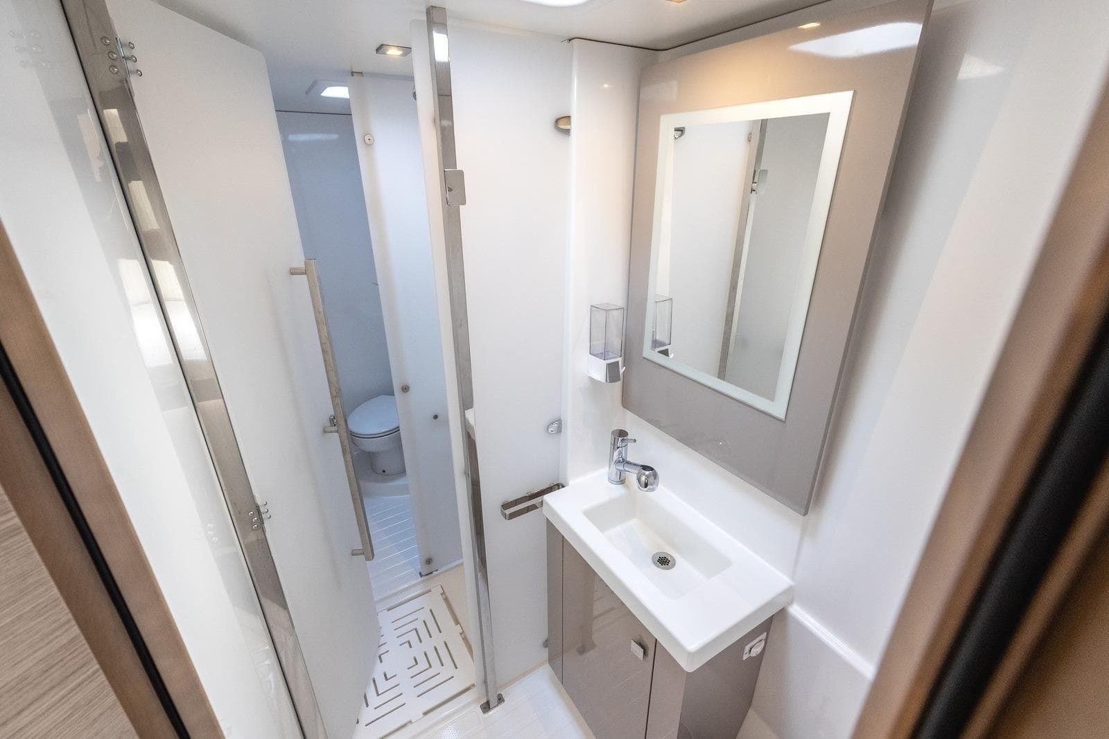 Modern bathroom in 2023 Fountaine Pajot Astrea 42 Maestro yacht, featuring sleek sink and mirror.