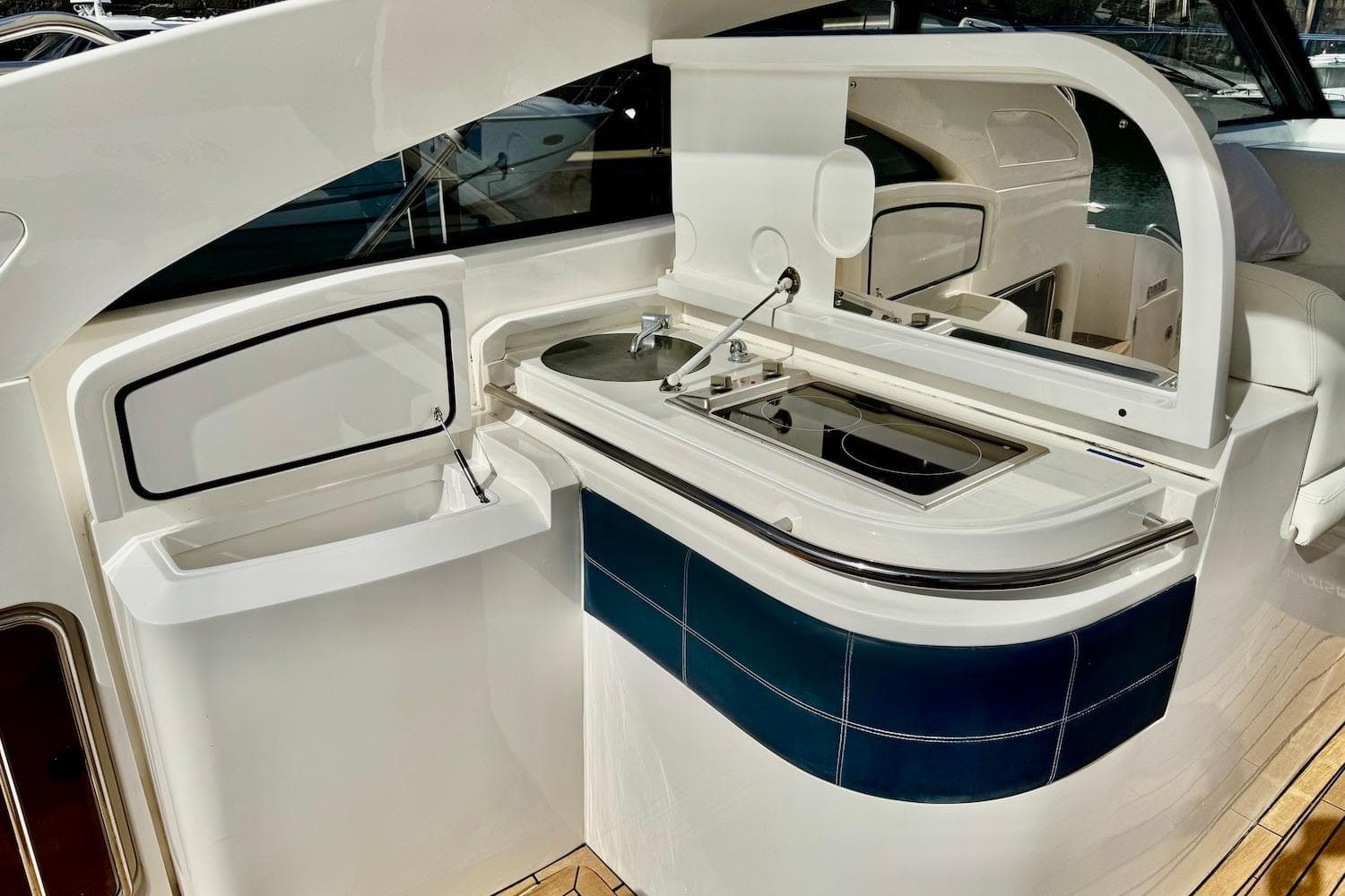 Interior view of a 2011 Princess V42 yacht kitchen area with stove and sink.