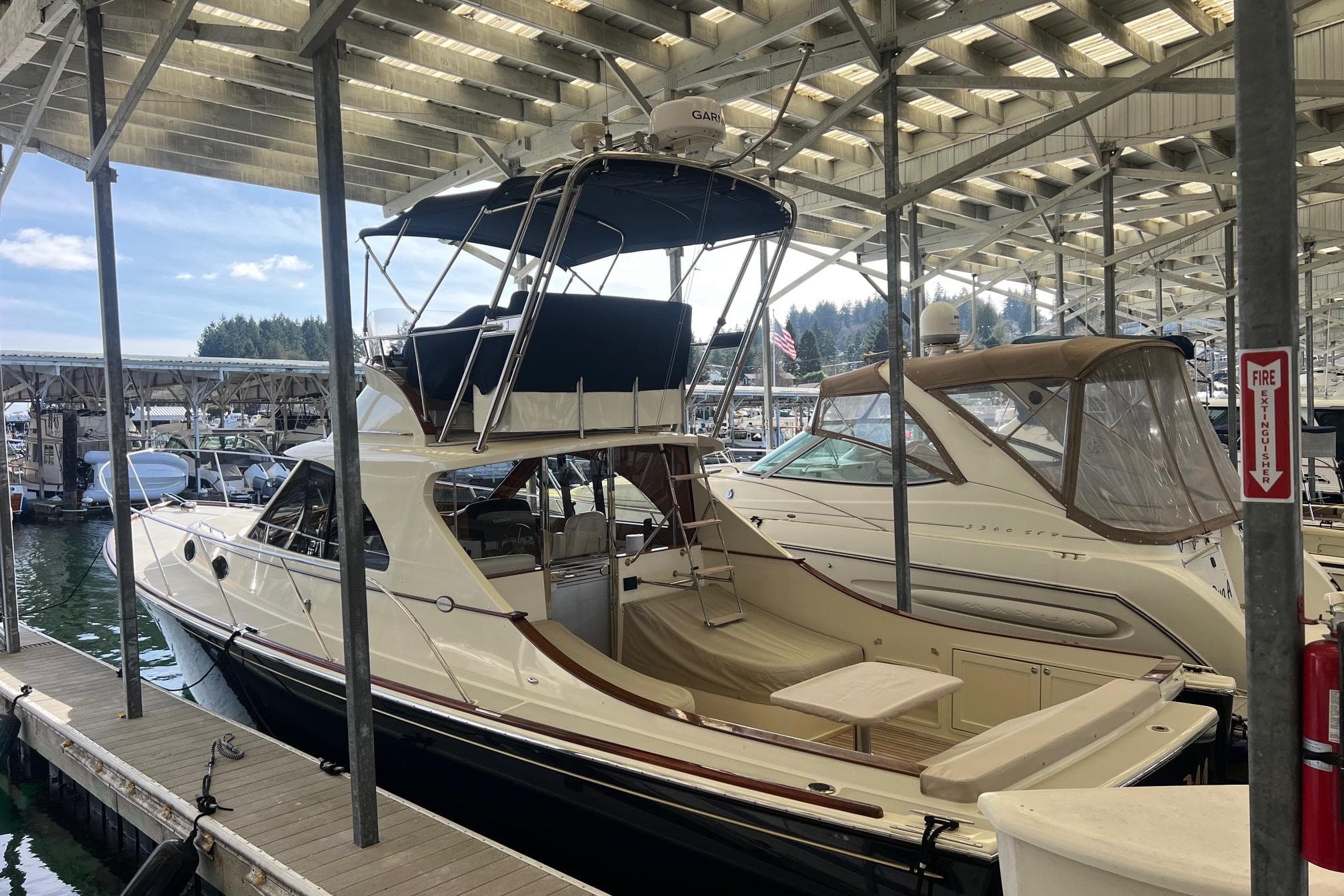 2010 San Juan SJ40FB IPS yacht docked in a marina under a covered structure.