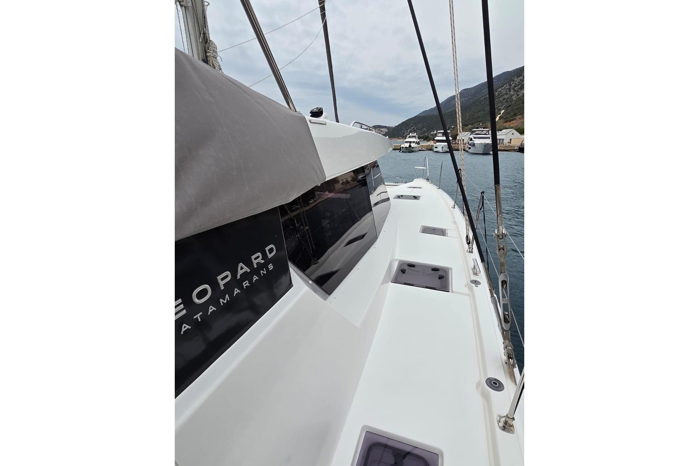 2024 Leopard 50 catamaran docked in a scenic marina setting.