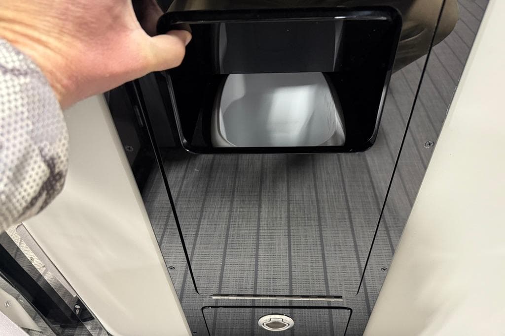 Hand opening compartment on 2025 Balise Horizon 24 boat with sleek interior design.
