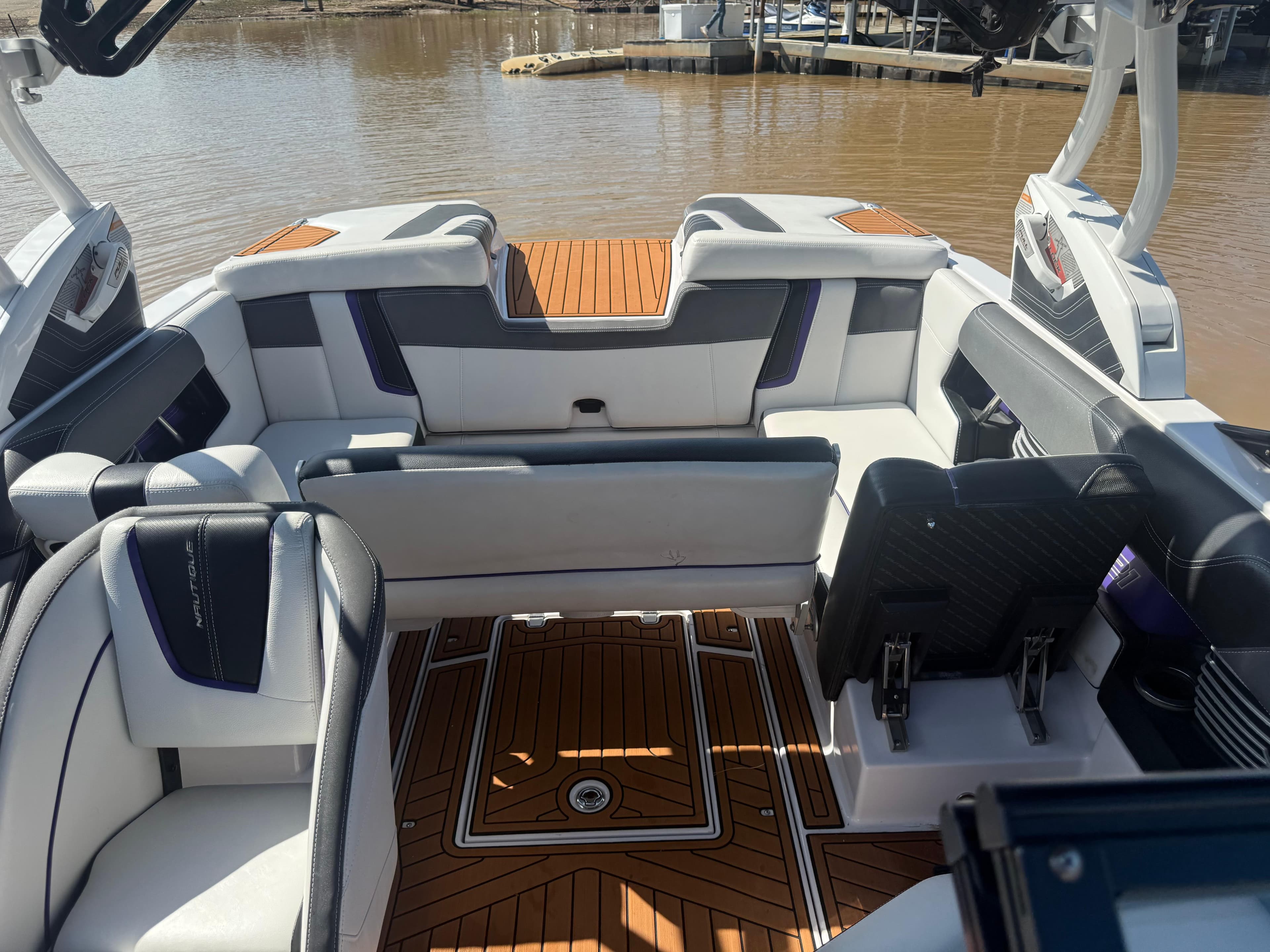 2014 Nautique Super Air Nautique G21 interior with luxurious seating and teak flooring.