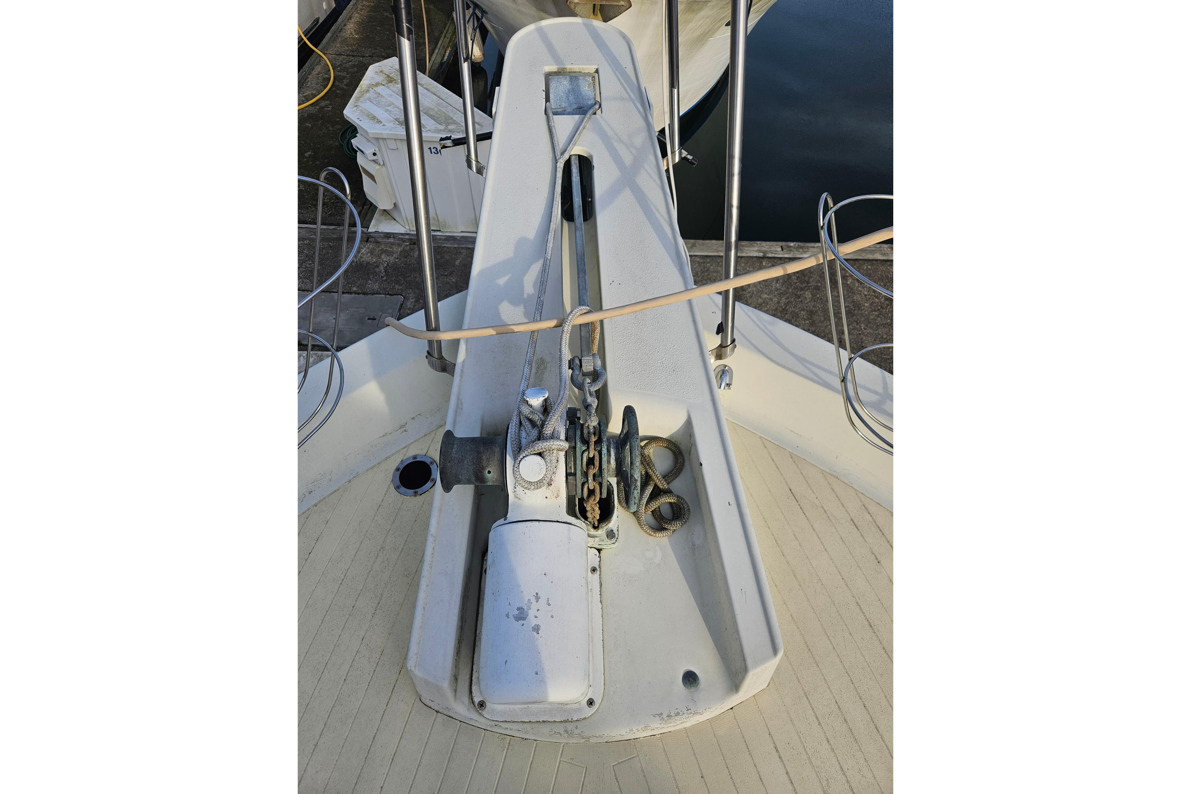 1981 Tollycraft 43 Motor Yacht anchor system on deck, featuring winch and railing.