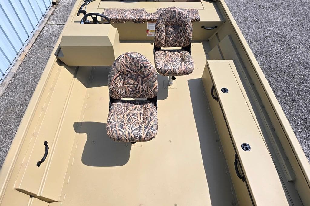 2026 Lowe Roughneck RX2070 Tiller boat interior with camo seats and storage compartments.