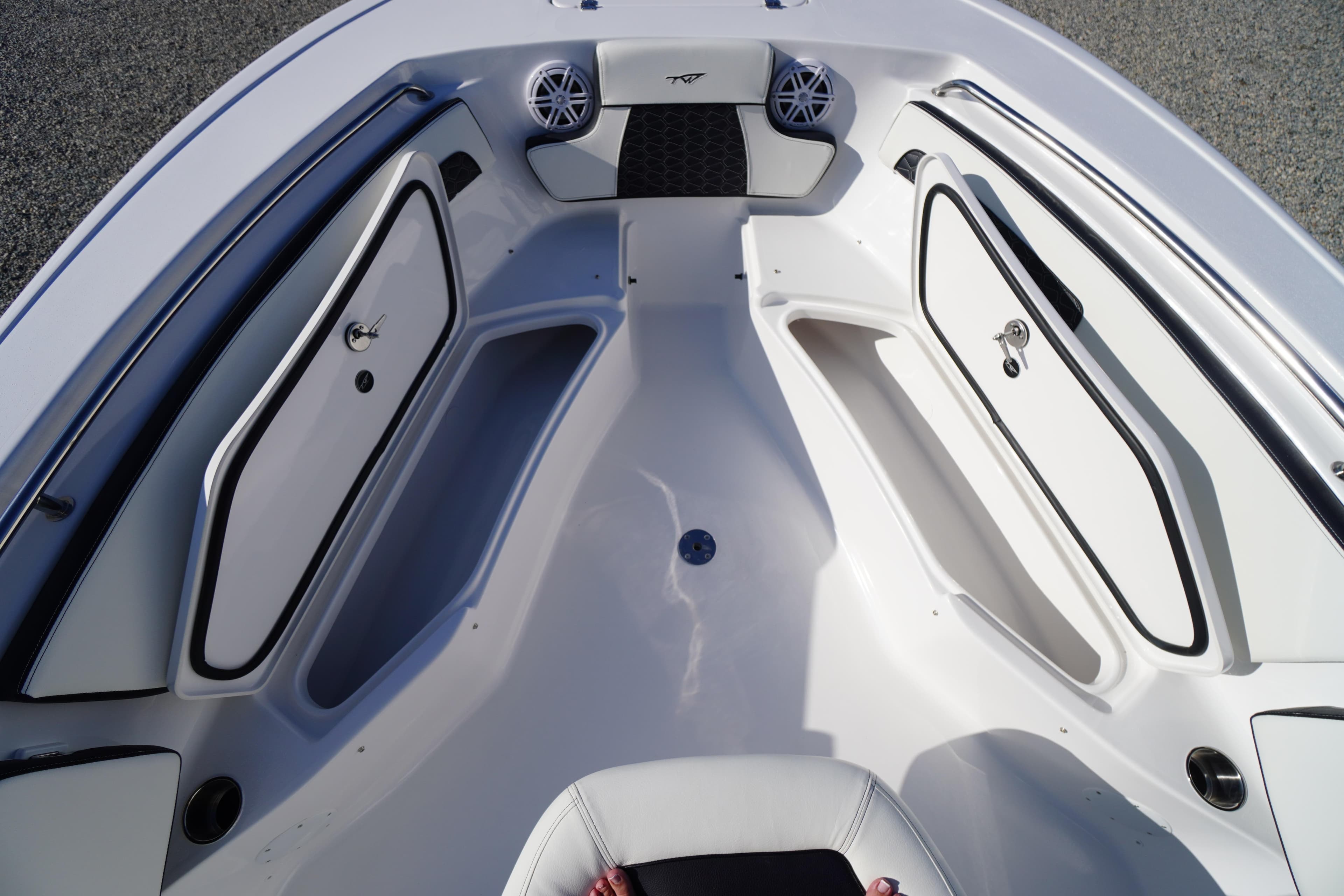 2026 Tidewater 220 LXF boat interior with storage compartments and speakers.