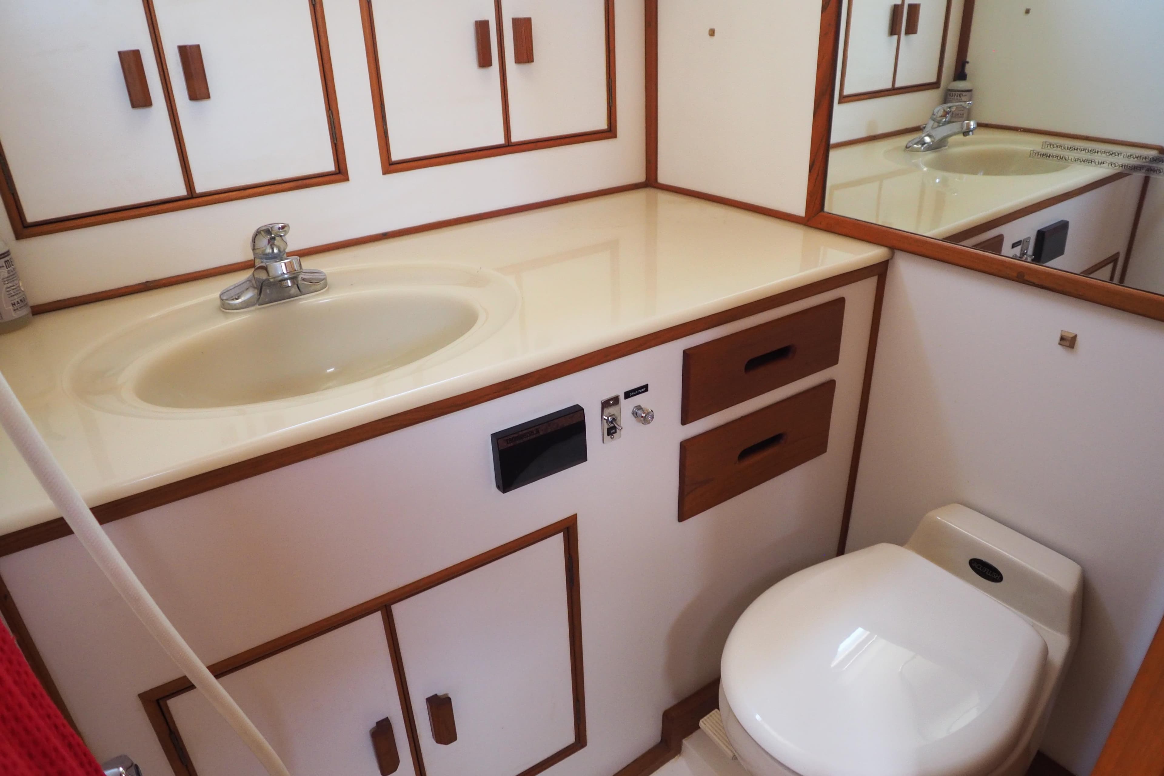 Bathroom interior of 1995 Grand Banks 38 Eastbay EX yacht, featuring sink and toilet.