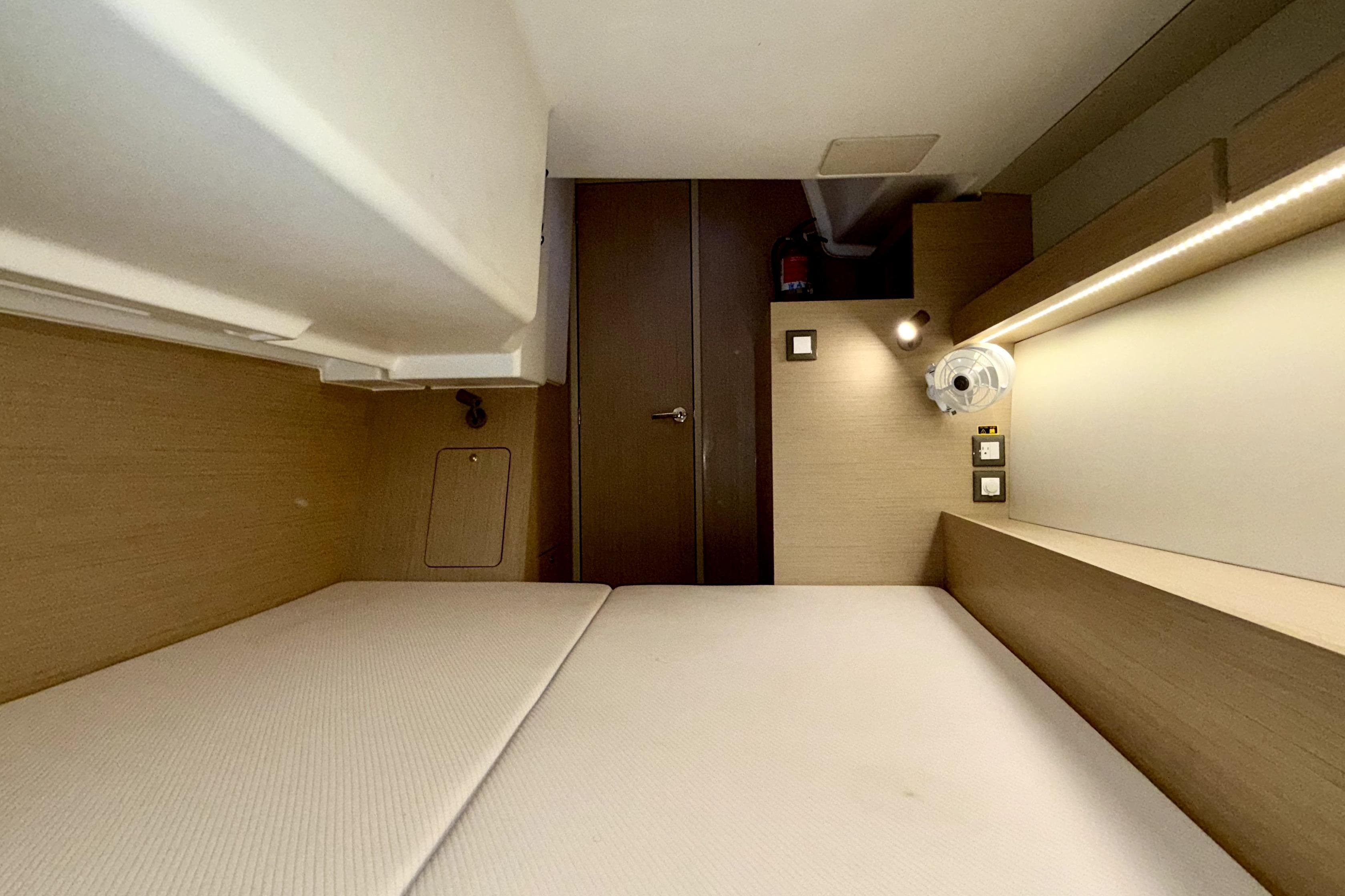 2023 Beneteau Oceanis 34.1 cabin interior with modern wood finish and ambient lighting.