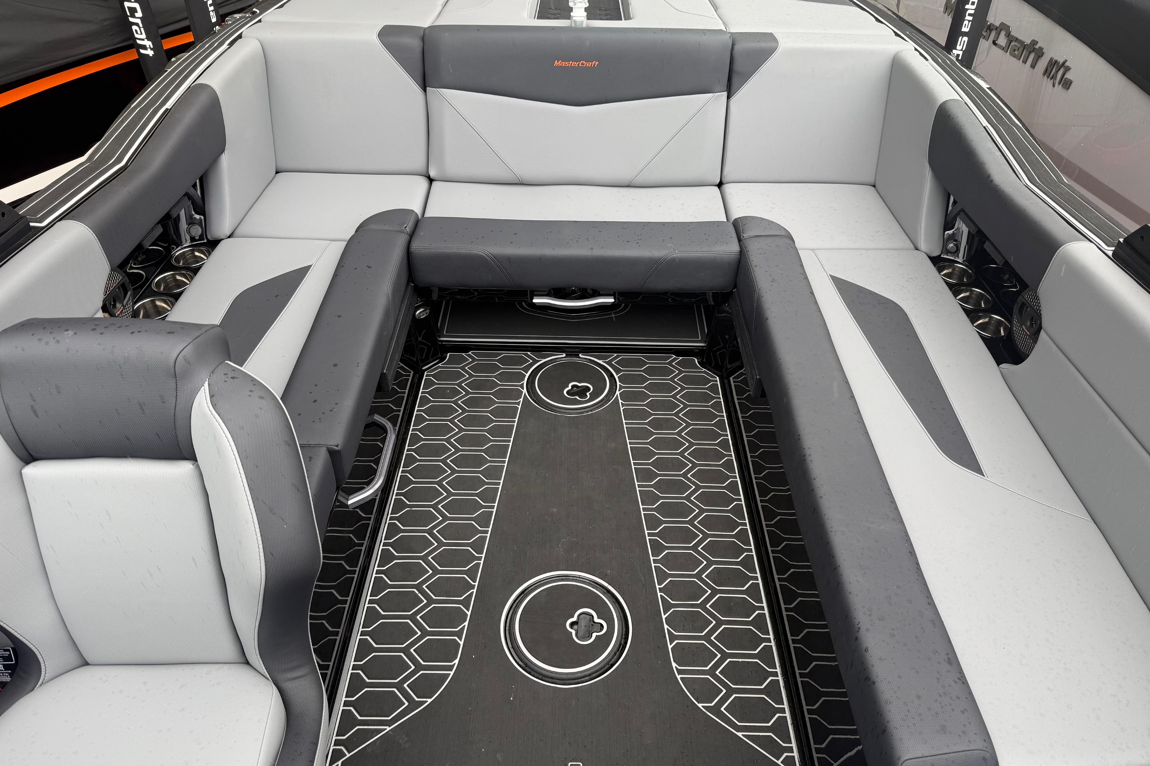 Luxurious interior of 2025 MasterCraft NXT23 boat with sleek seating and modern flooring.