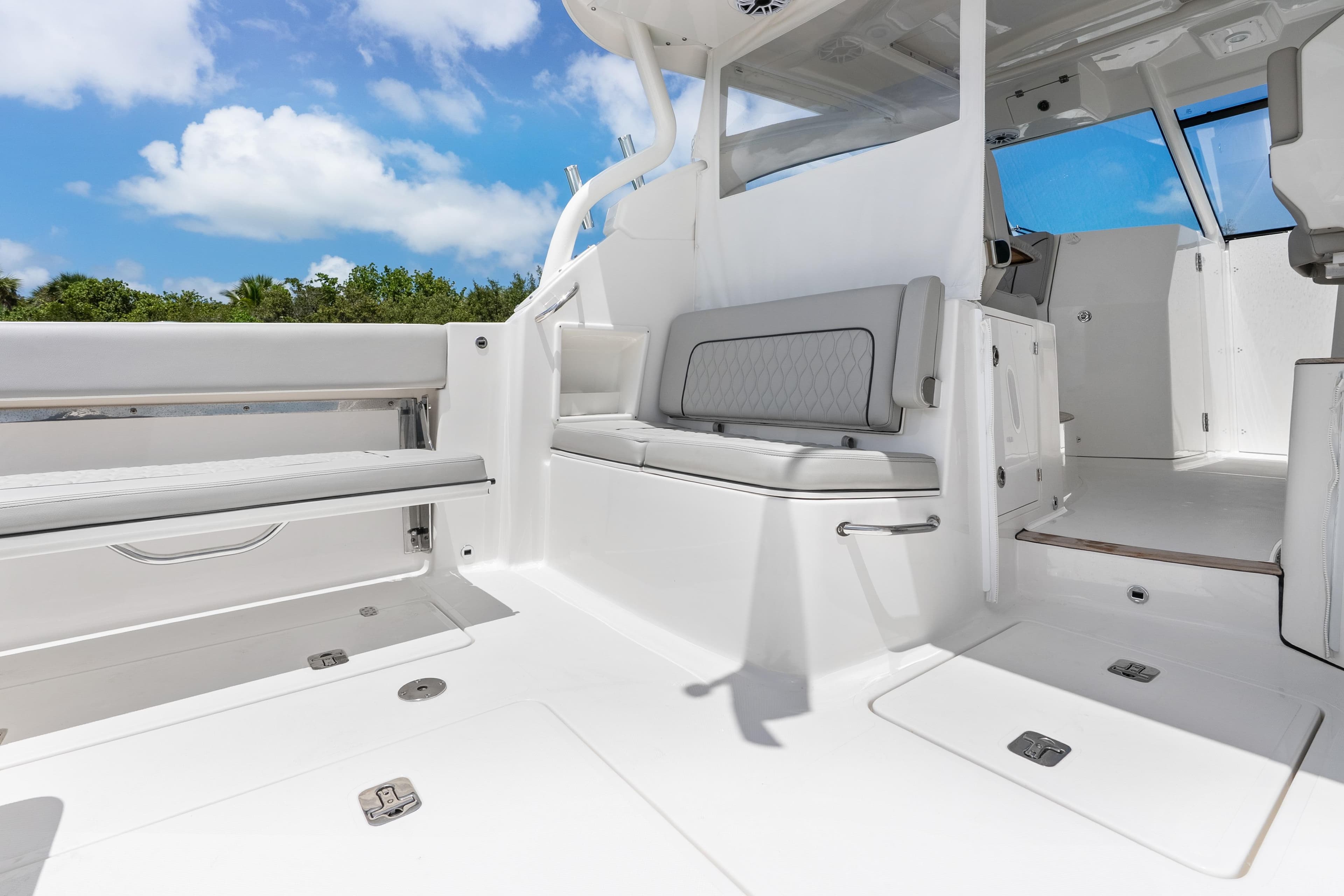 2026 Pursuit DC 365 Dual Console boat interior with seating and open deck under blue sky.