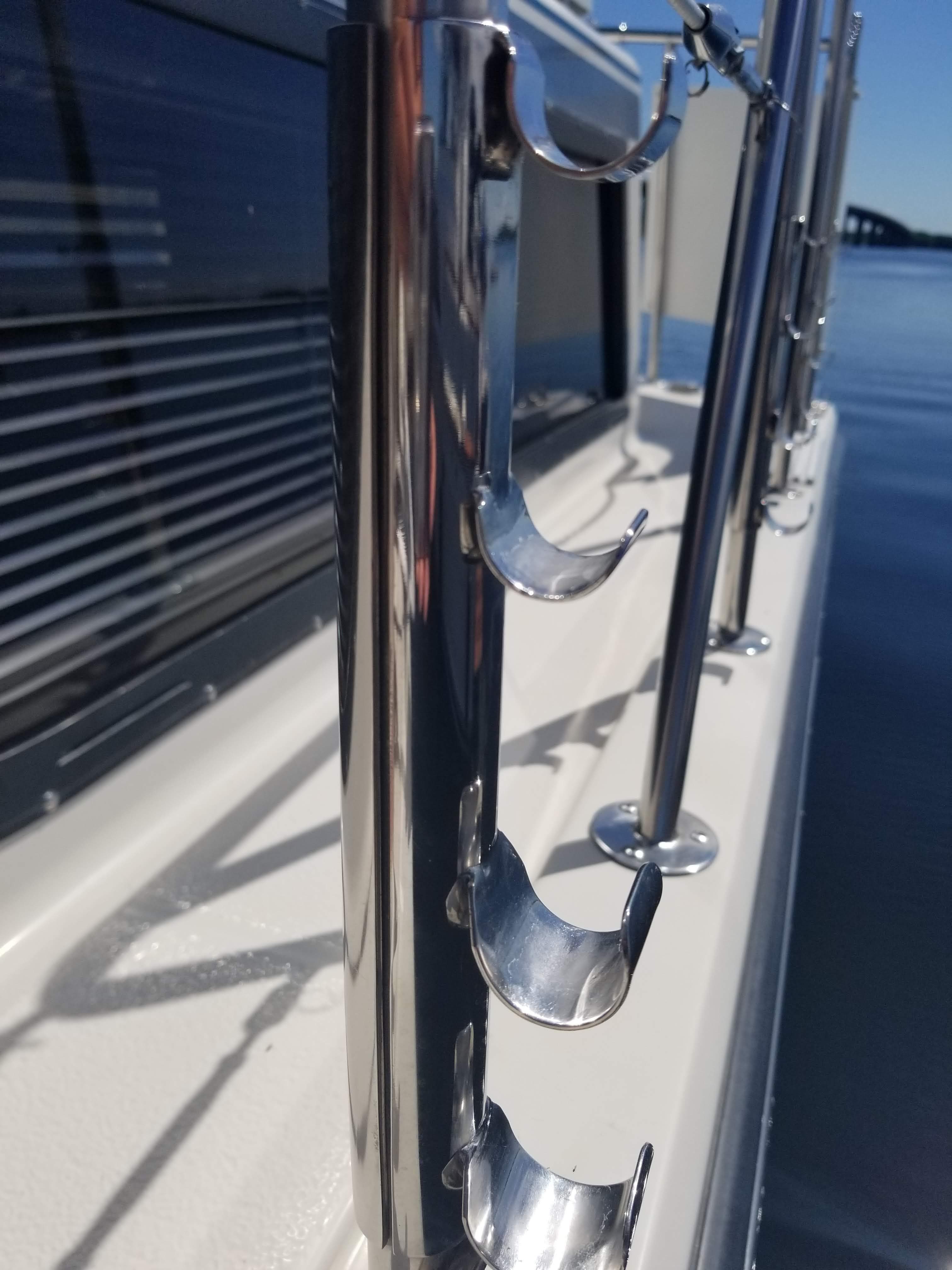 Close-up of 1989 Chris-Craft Catalina 381 boat railing with rod holders.