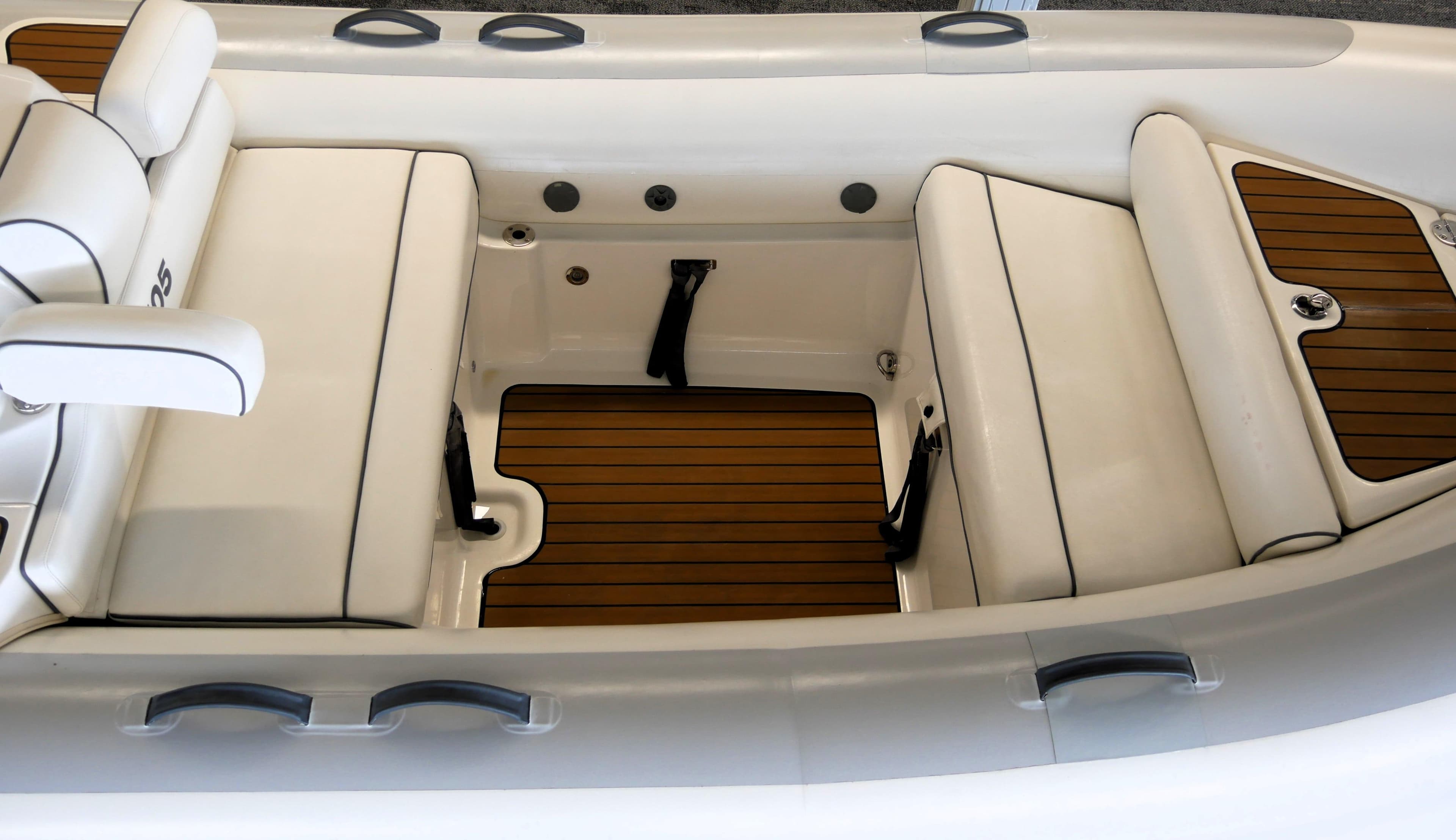 2010 Williams Jet Tenders Turbojet 505D interior with white seating and wooden flooring.