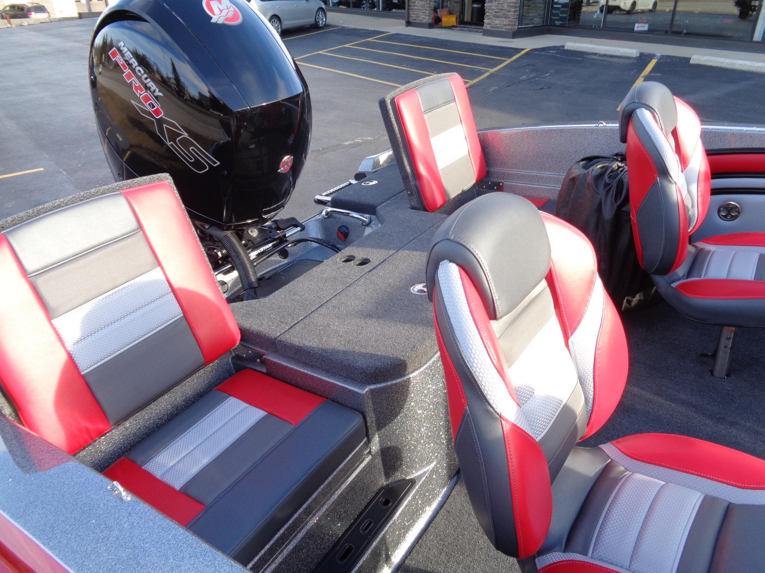 2024 Ranger 1850 Reata boat interior with red and gray seats and motor.