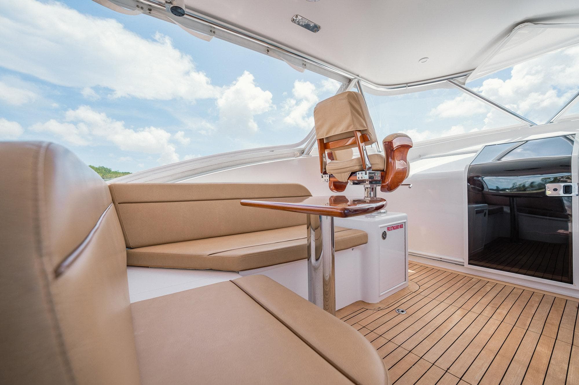 Luxurious interior of 2012 Winter Custom Yachts 38 Express with leather seating and wooden flooring.