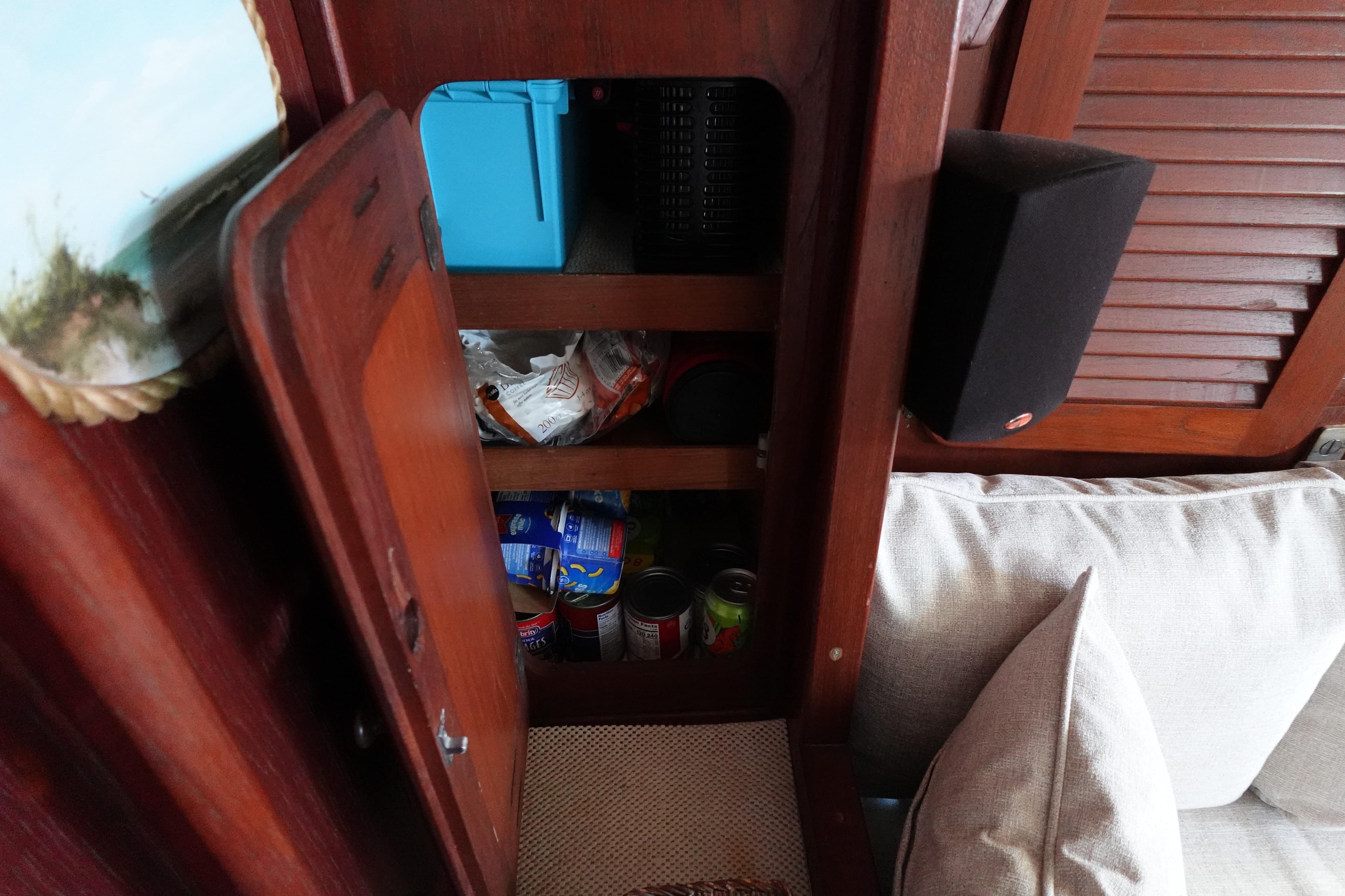 Wooden cabinet with canned goods and storage on a 1978 Morgan 382 sailboat.
