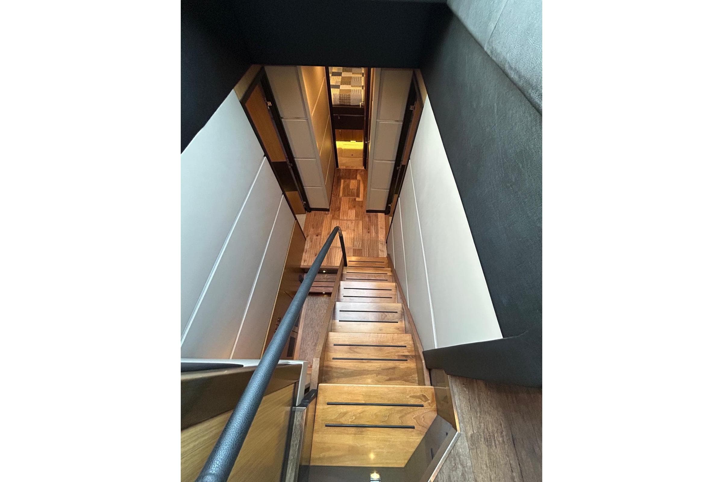 Staircase inside 2016 Sea Ray L650 yacht, featuring sleek wooden steps and modern design.